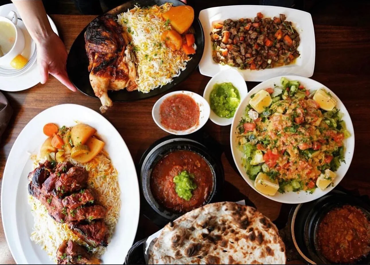 Assorted Middle Eastern dishes including grilled chicken and kebabs