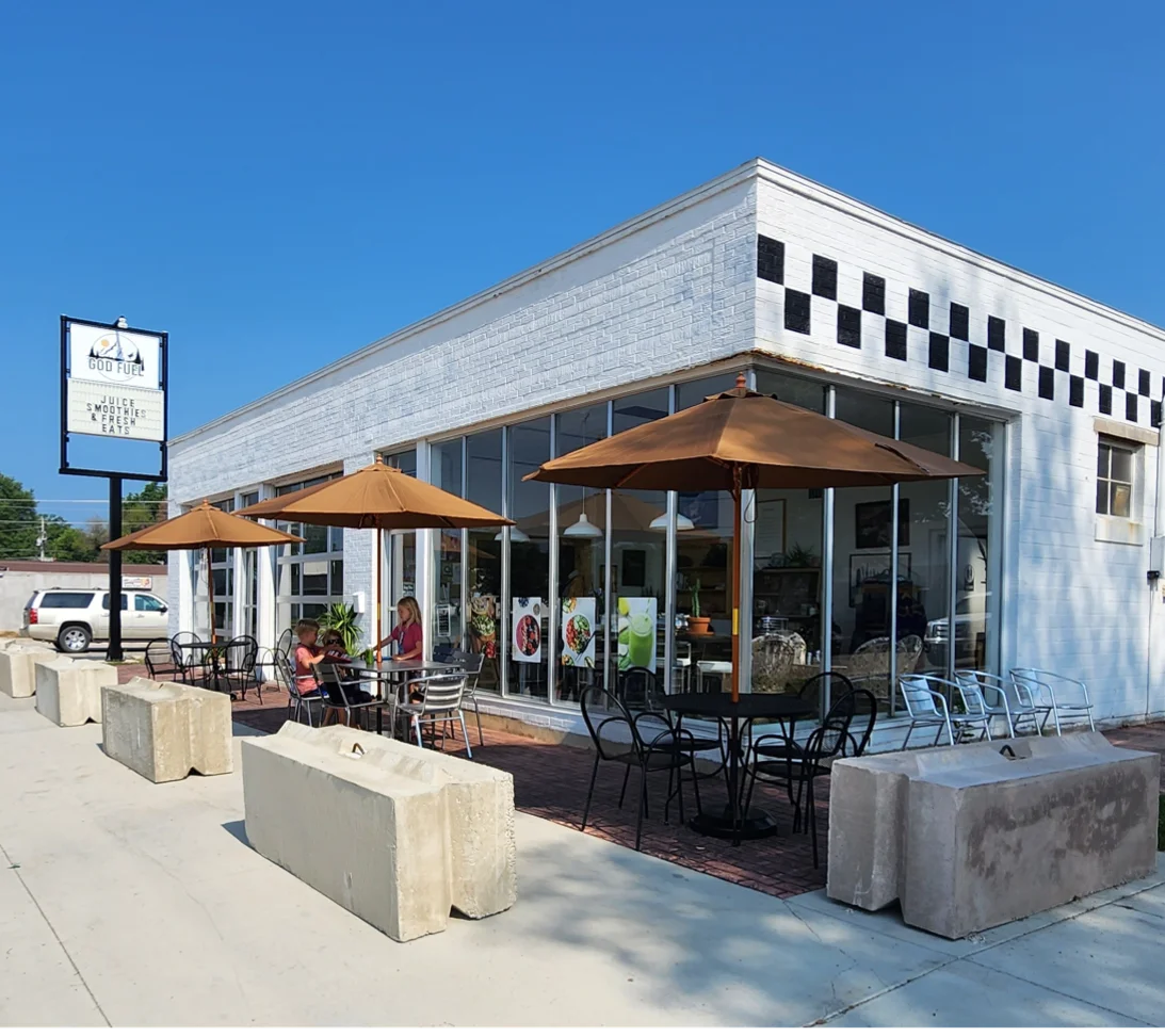 Charming café exterior with outdoor seating and umbrellas