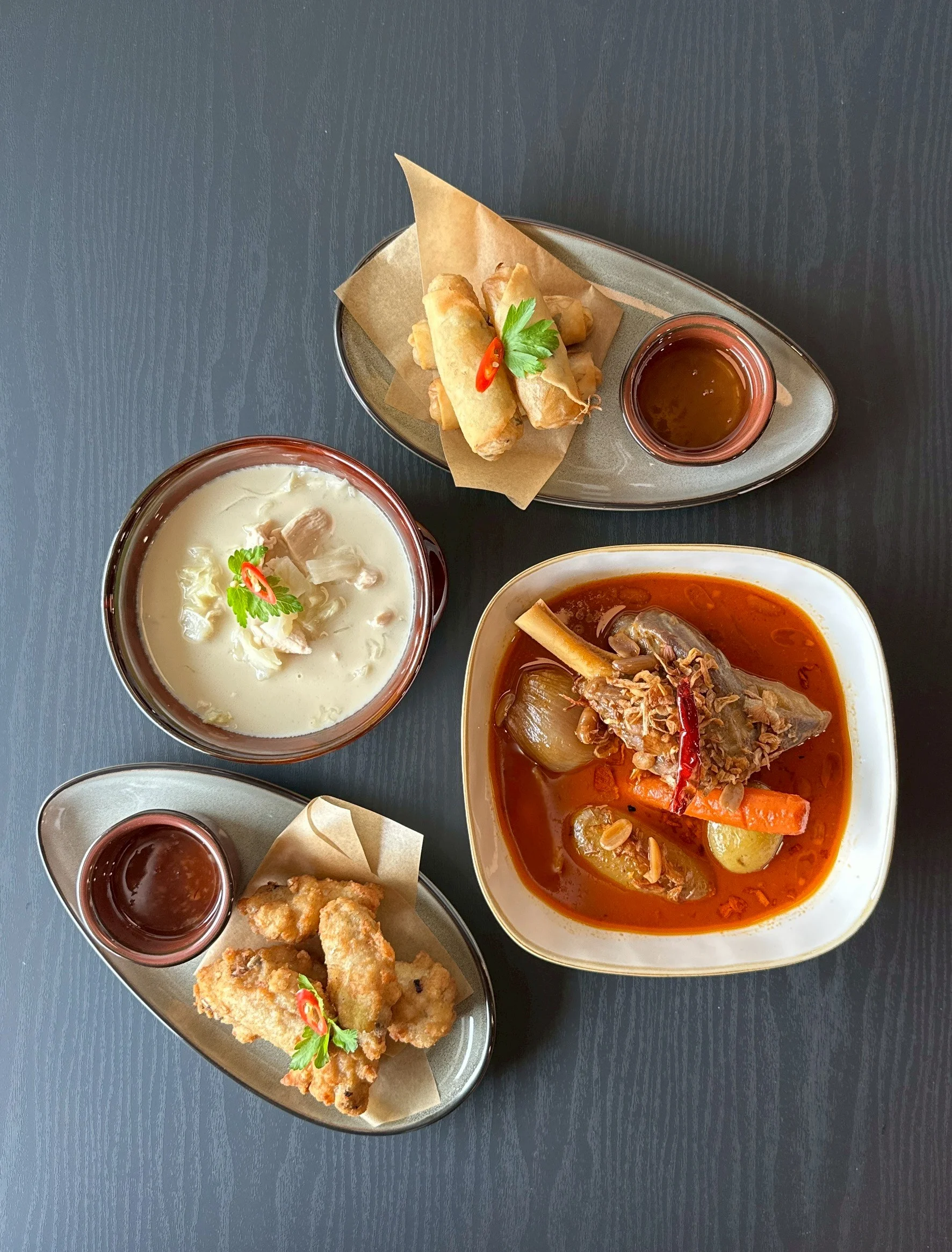 Indonesian beef rendang with spring rolls and coconut soup