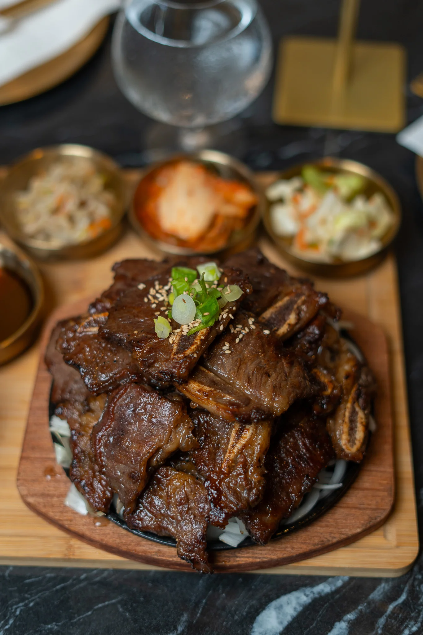 Sizzling Korean galbi served with rice and side dishes