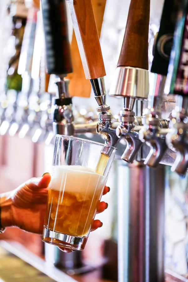 Bartender pouring craft beer from a tap