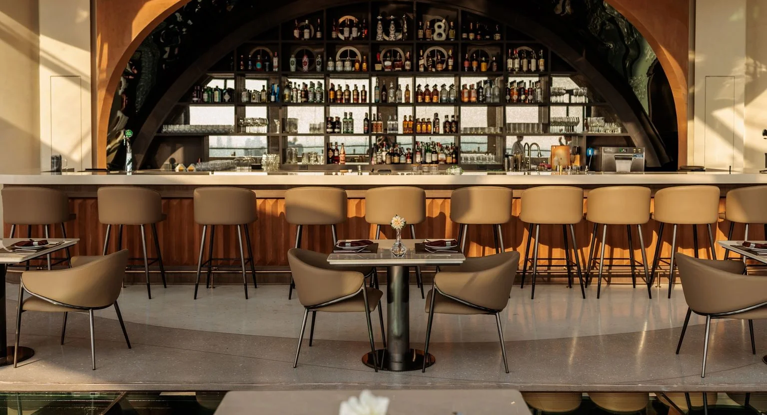 Modern restaurant interior with a stylish bar and seating