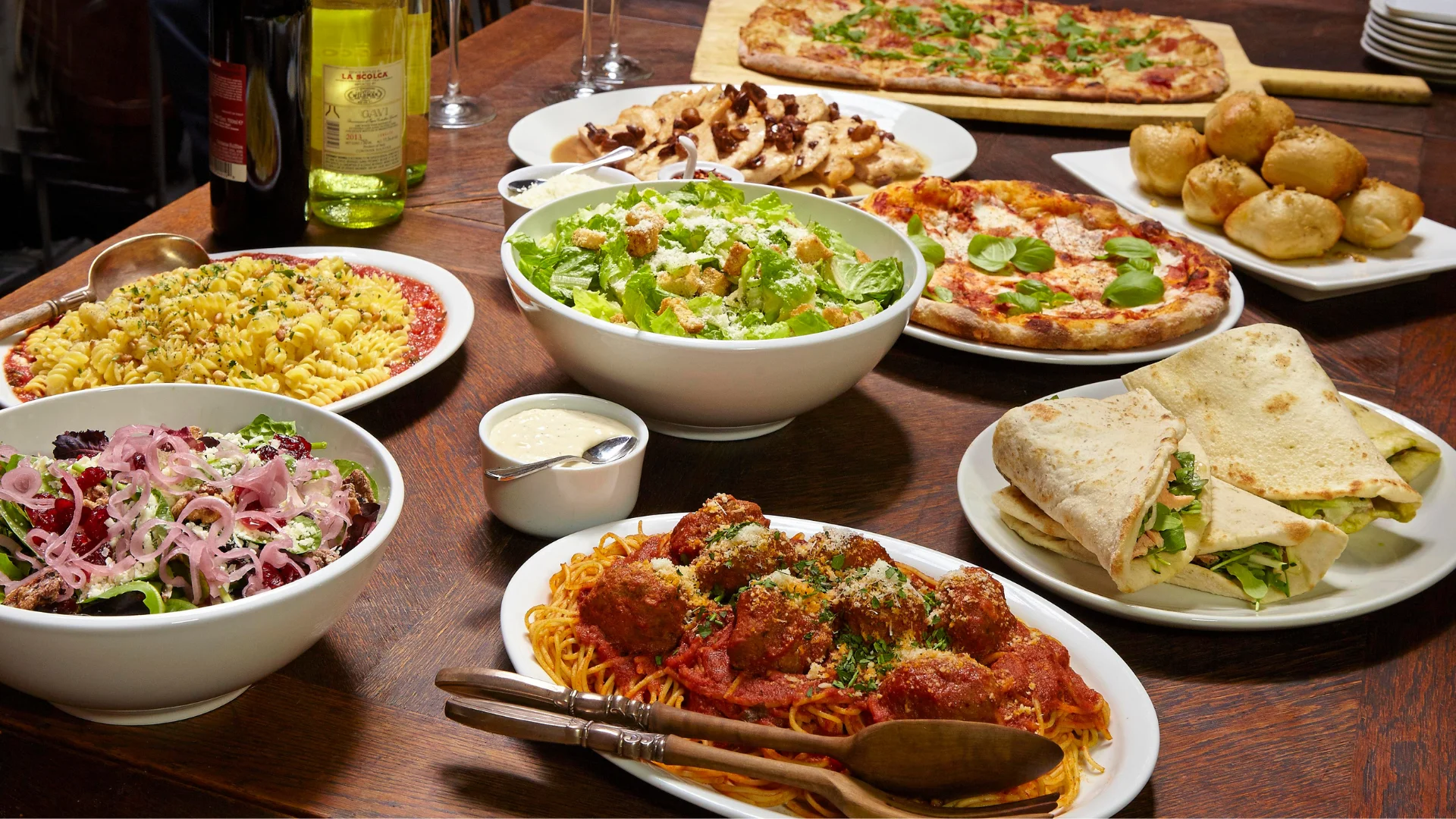 catering food display featuring meatballs, Caesar salad and Cheese Pizza