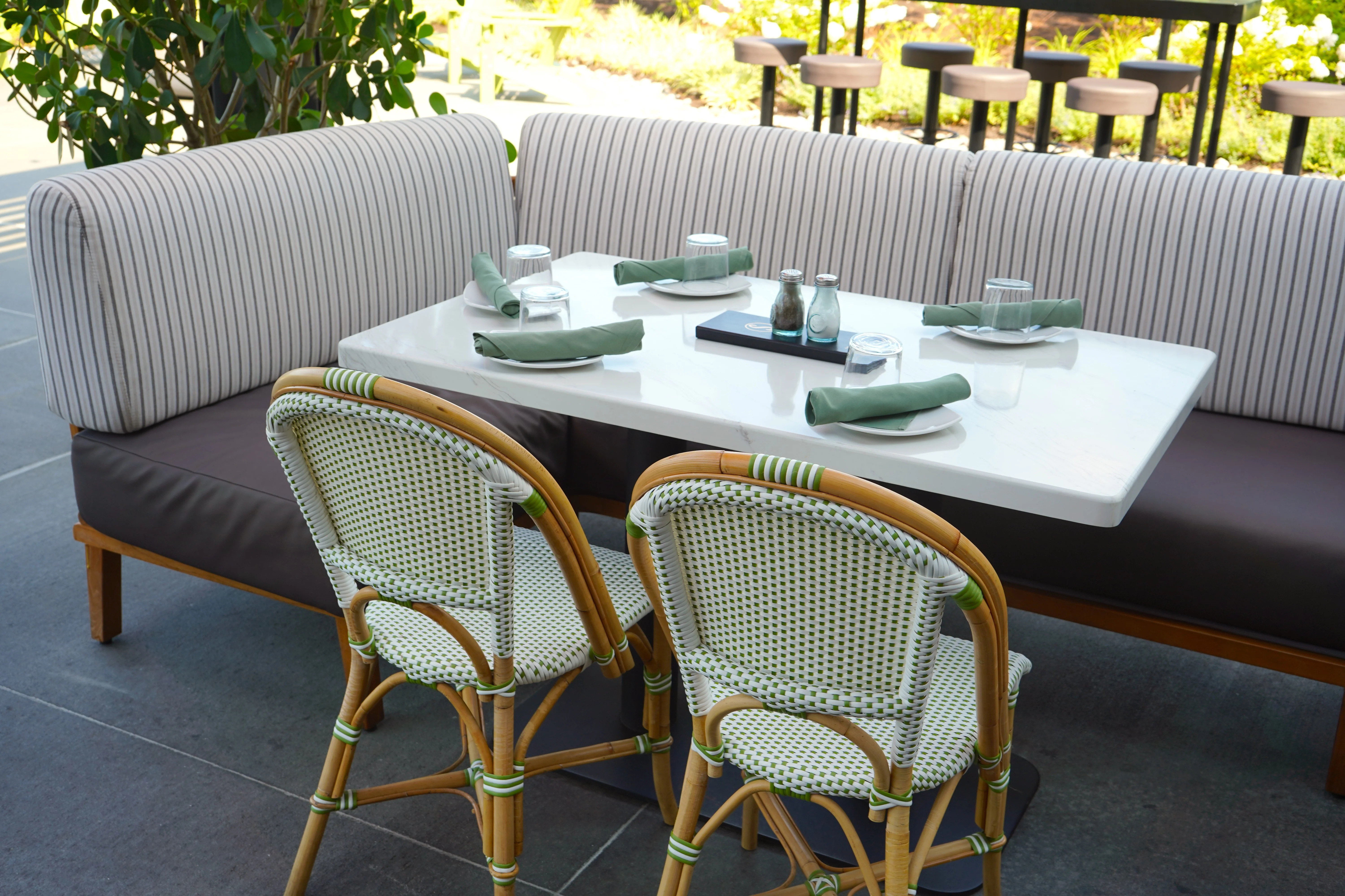 Stylish restaurant seating with green accents and modern decor