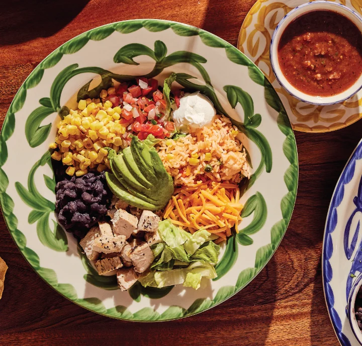 Colorful Mexican burrito bowl with chicken and fresh toppings