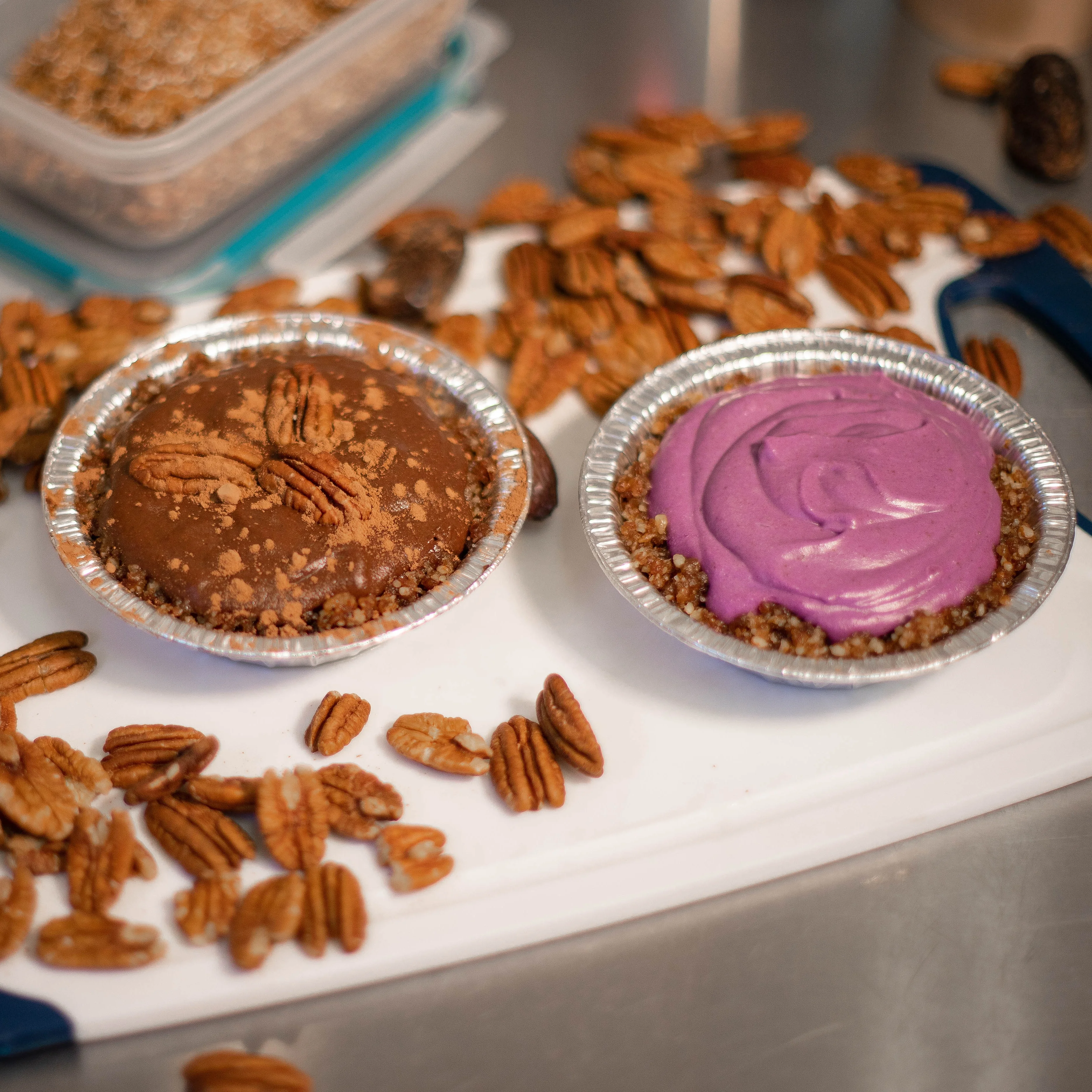 Decadent chocolate and berry tarts on a kitchen counter