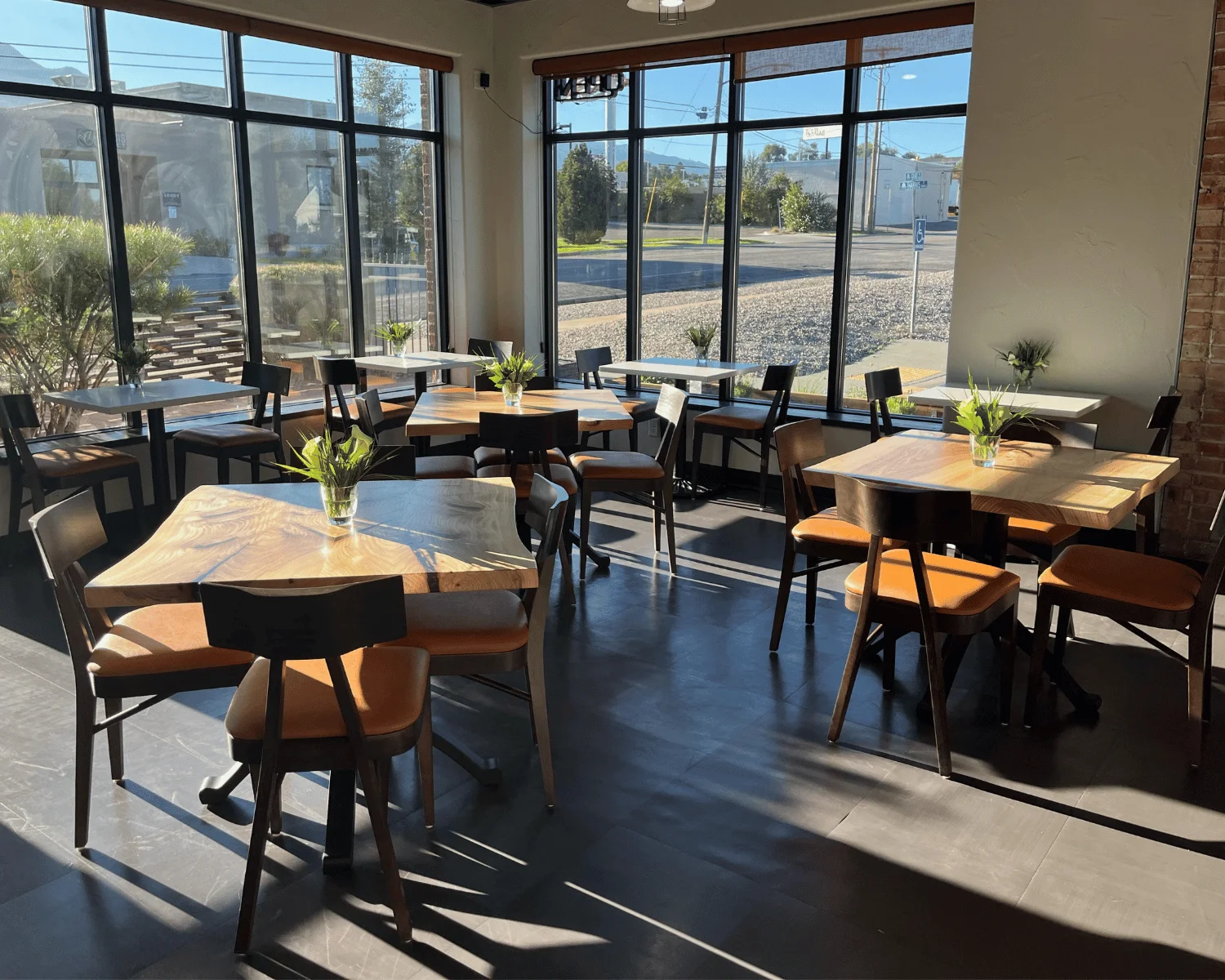 Cozy restaurant interior with natural light and wooden tables