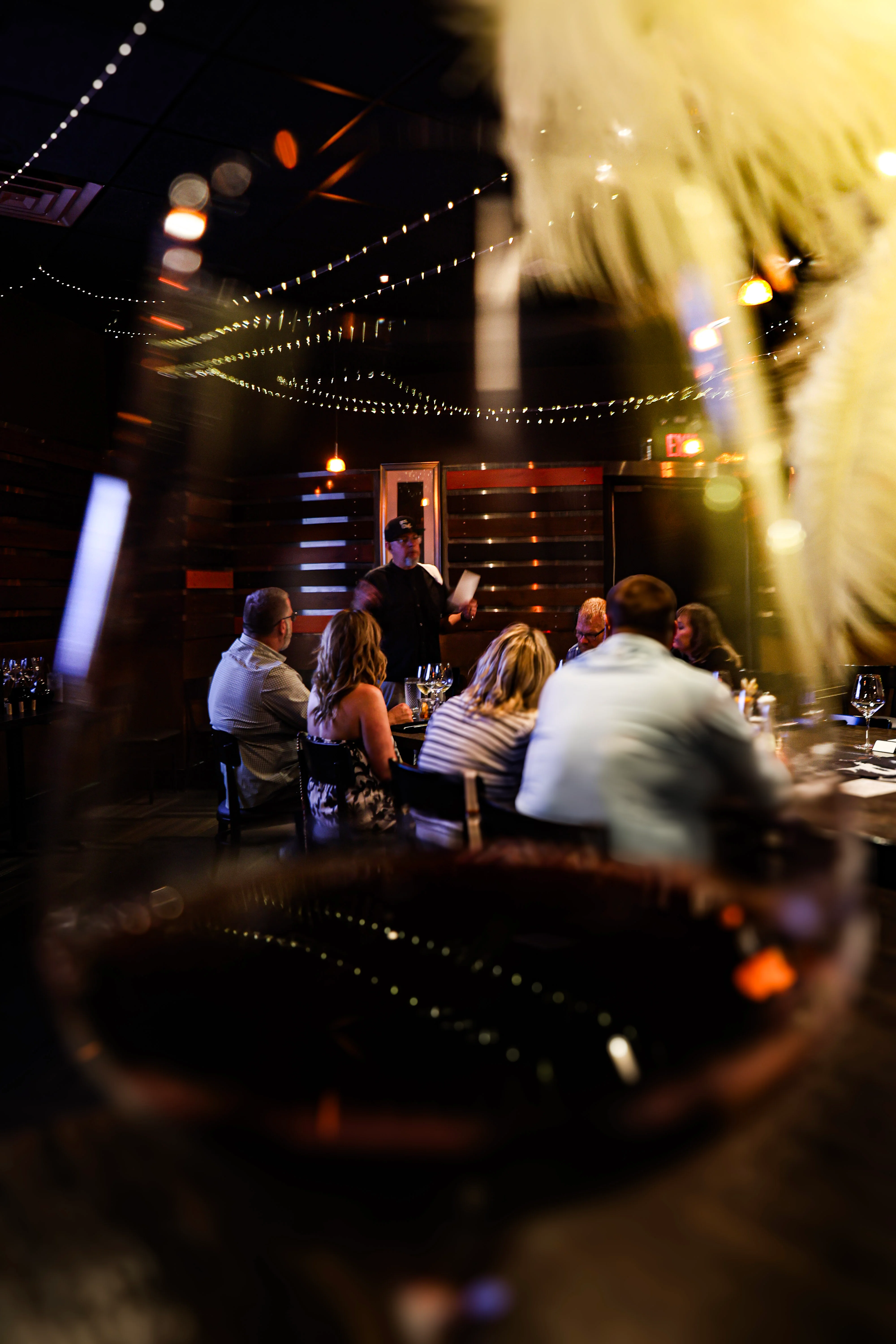 Cozy restaurant setting with guests enjoying a wine tasting event