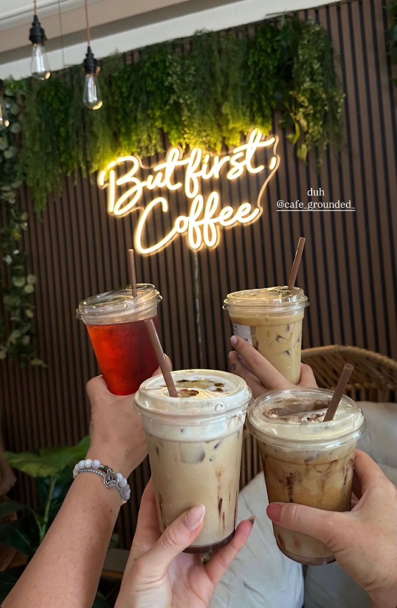 Barista pouring latte art into a white cup