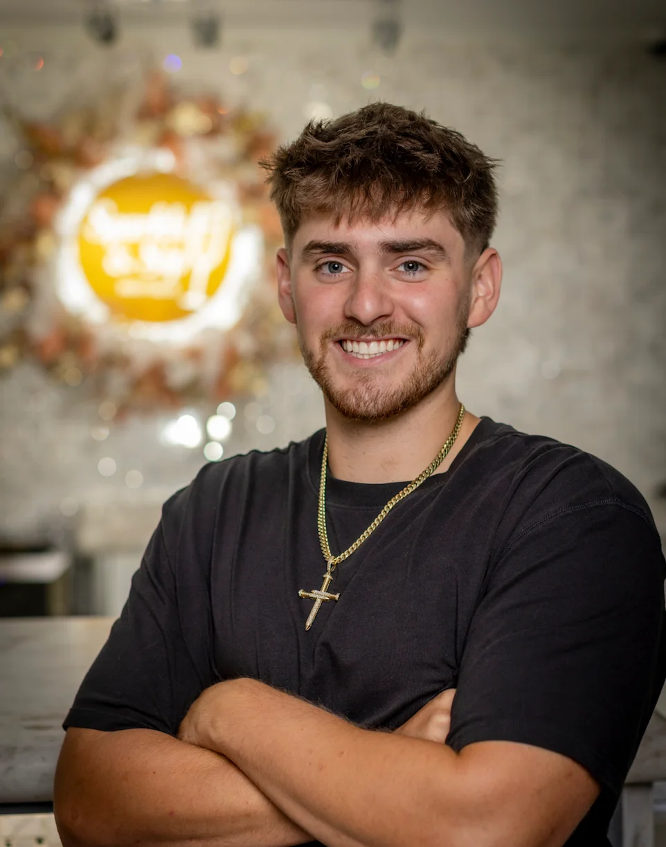 Smiling young man posing in a modern restaurant interior