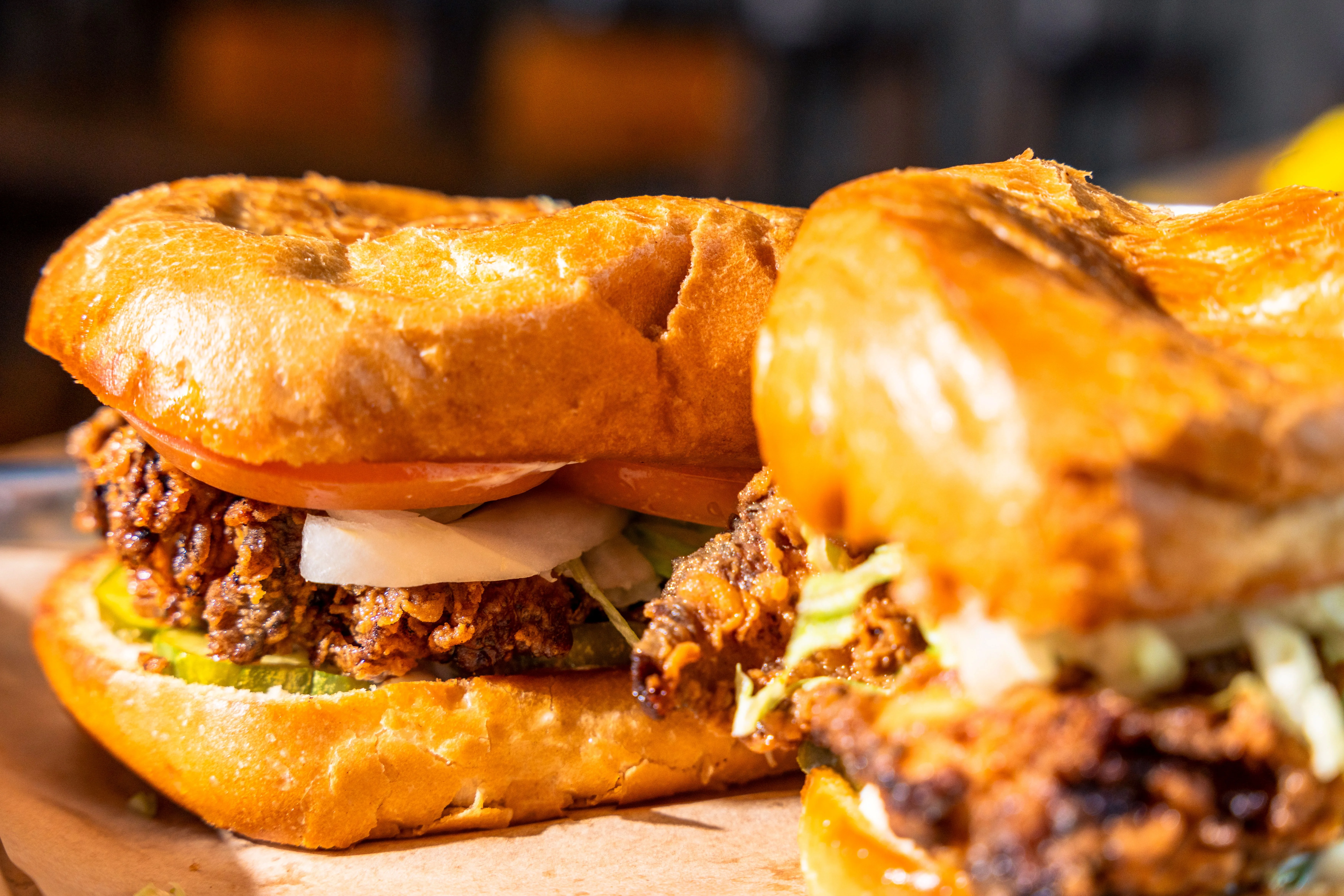 Crispy fried chicken sandwich with pickles and tomatoes