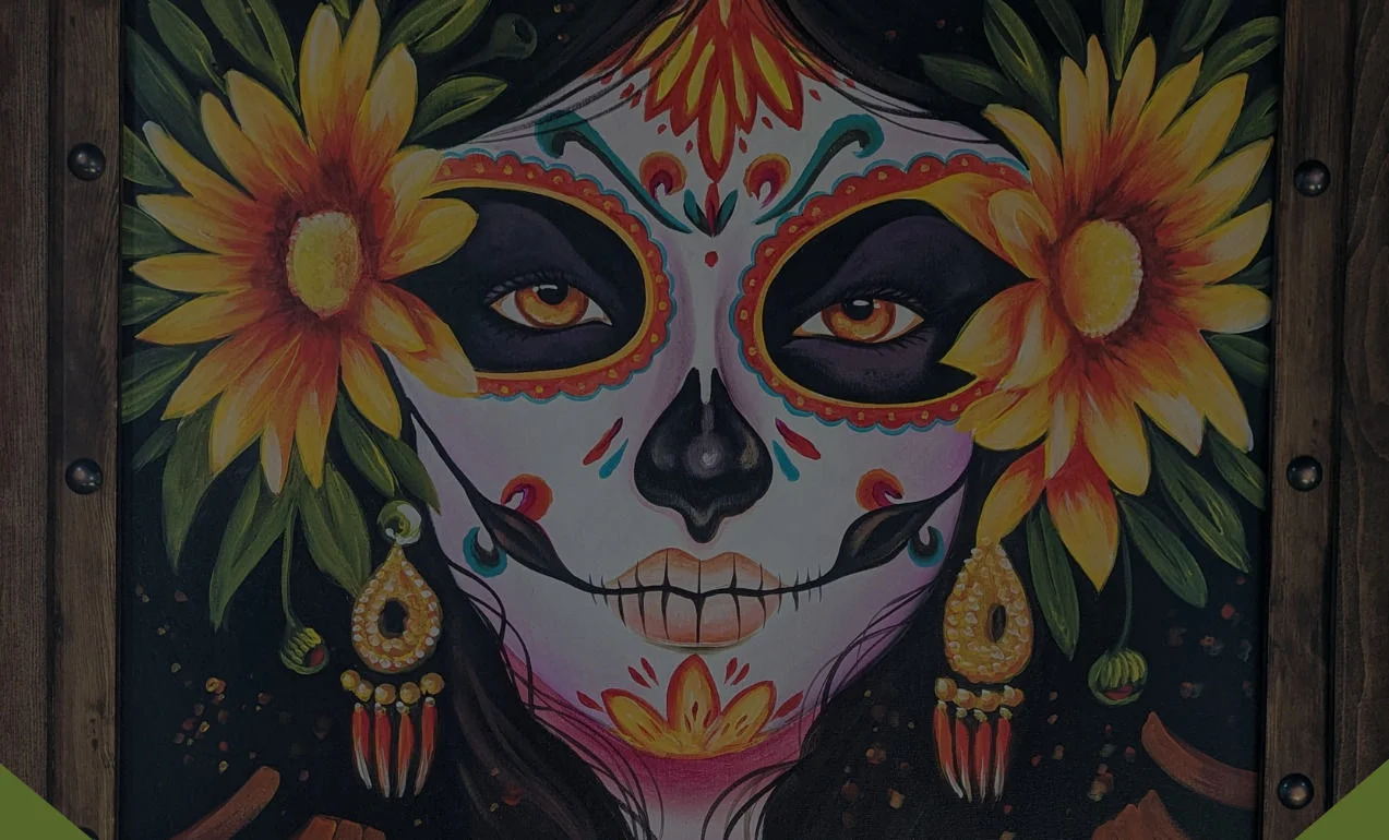 Colorful Day of the Dead artwork featuring a decorated skull face