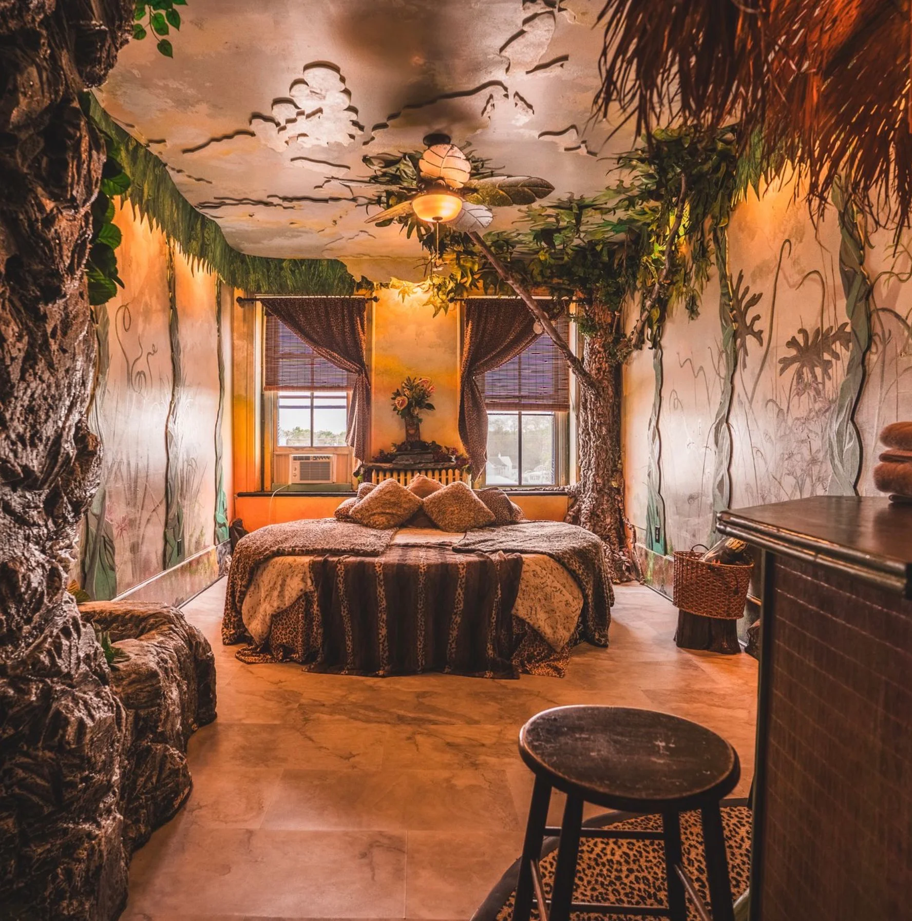Cozy themed bedroom with jungle decor and natural elements.