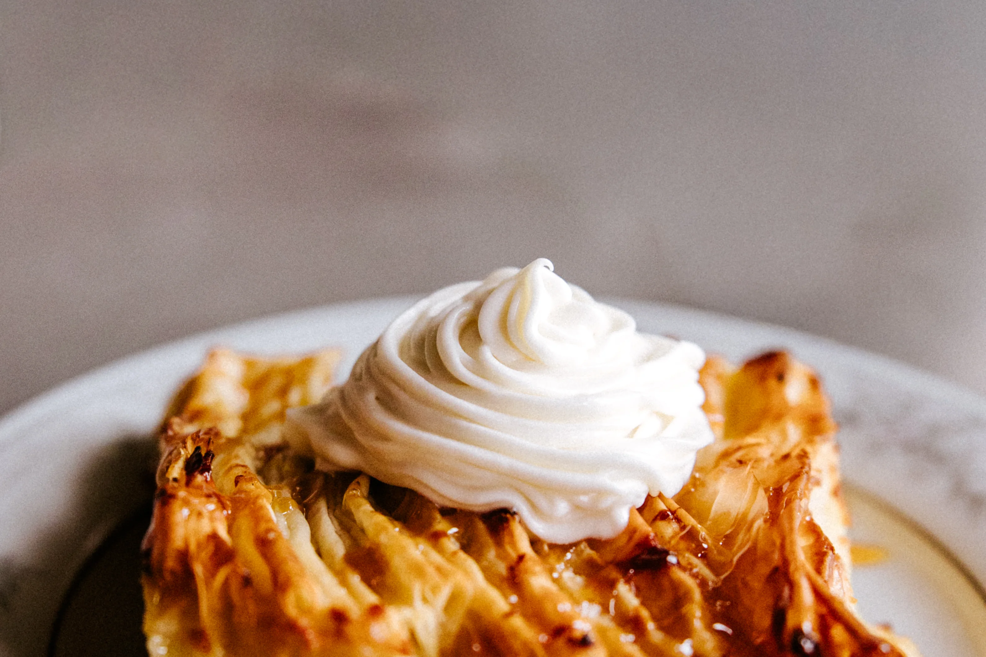Delicious slice of baklava topped with whipped cream