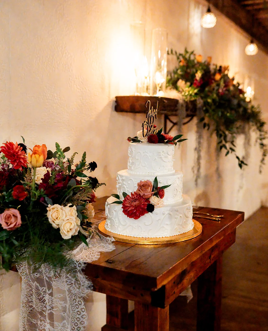Elegant wedding cake adorned with flowers and greenery