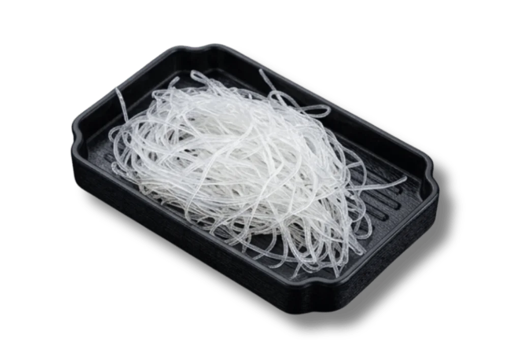 A pile of clear, thin noodles in a black tray.
