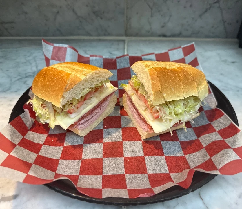 Pasquale’s cold sub sandwich served on red-and-white deli paper