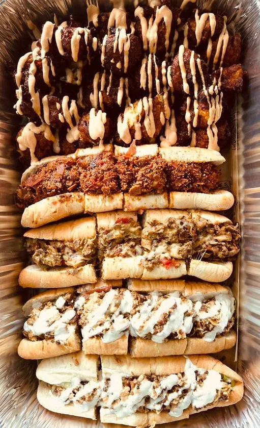 Assorted hoagies with savory fillings and drizzled sauces