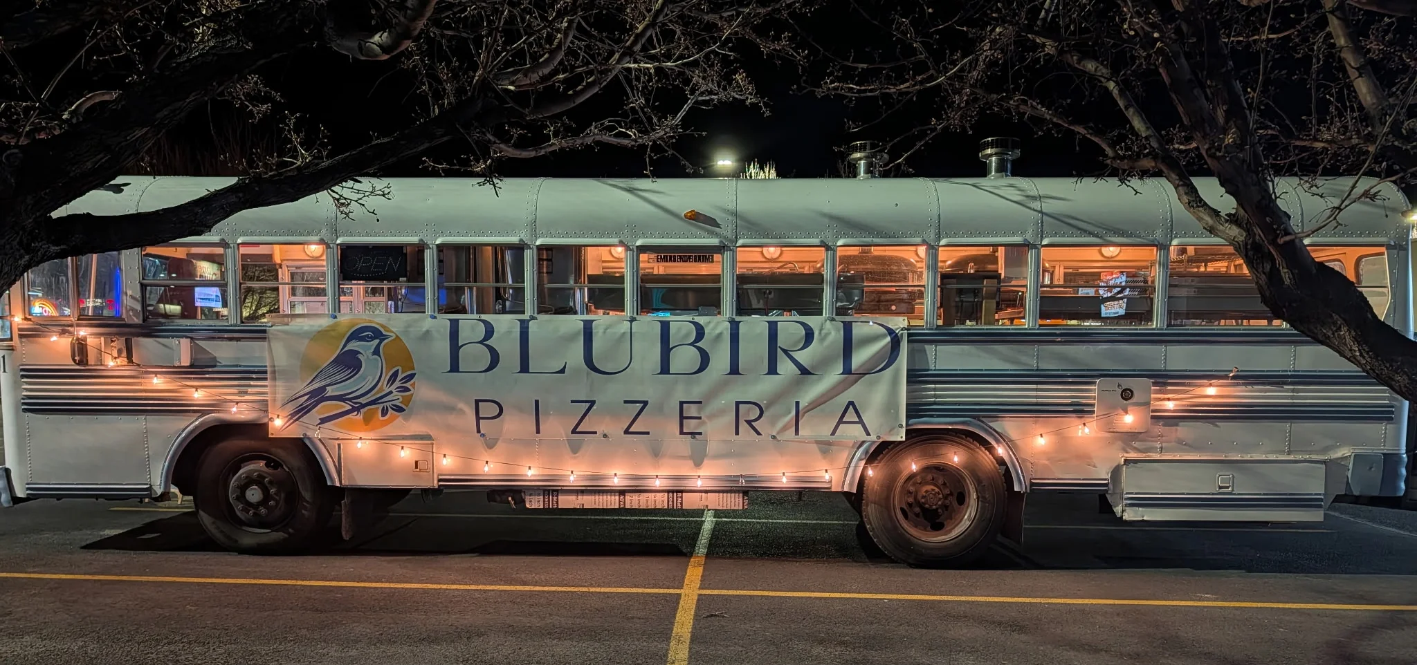 Food truck serving pizza with a cozy ambiance