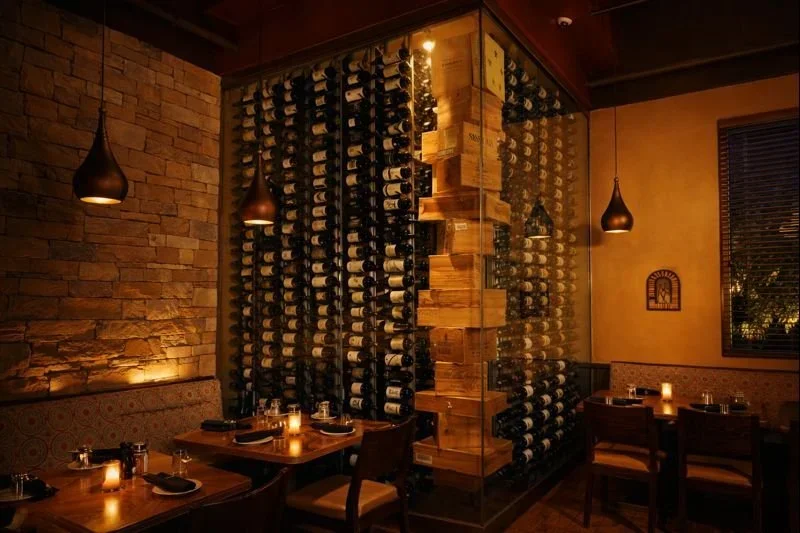 Elegant restaurant interior with wine wall and warm lighting