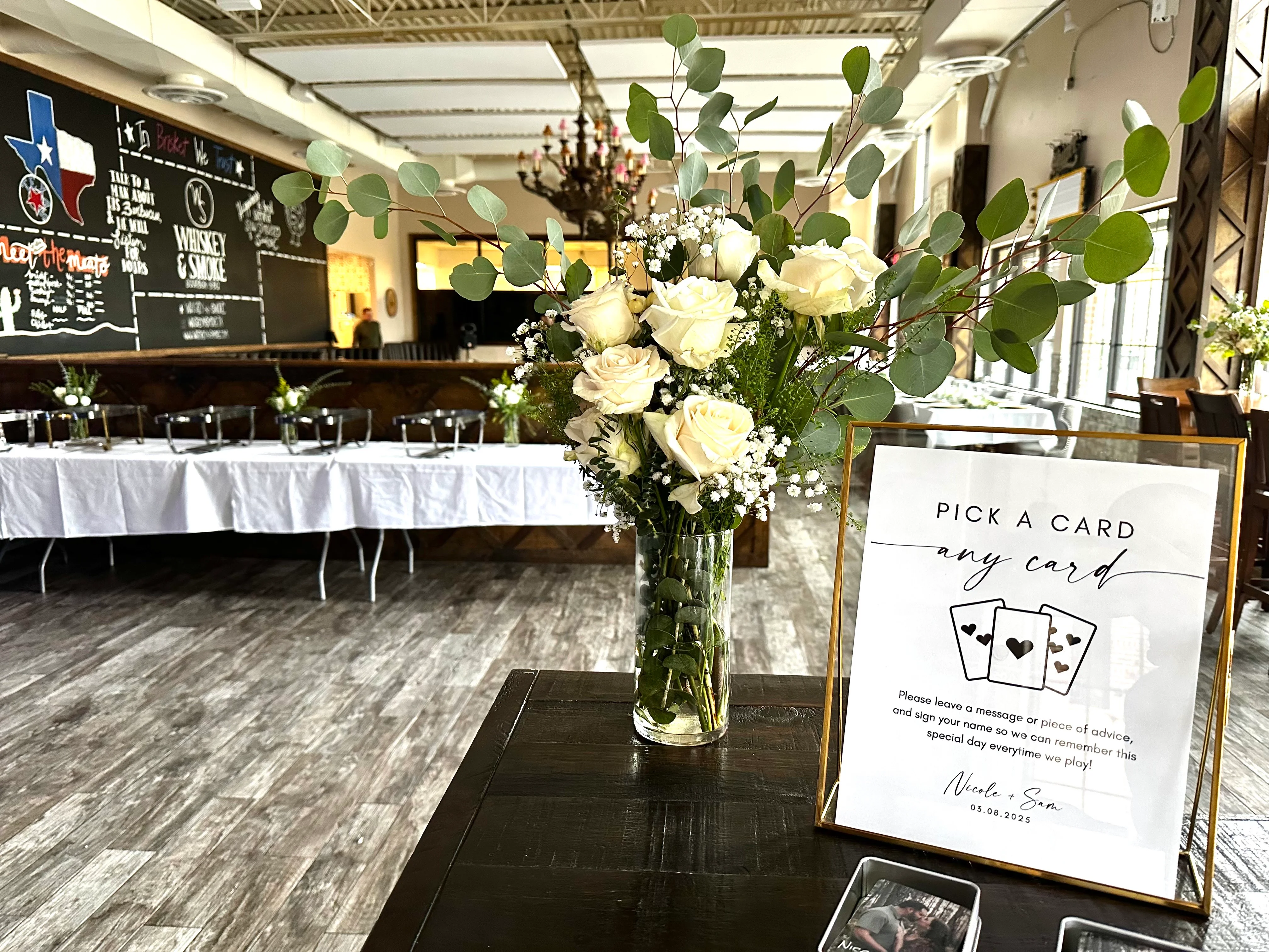 Elegant restaurant setup with floral arrangements and a card message display