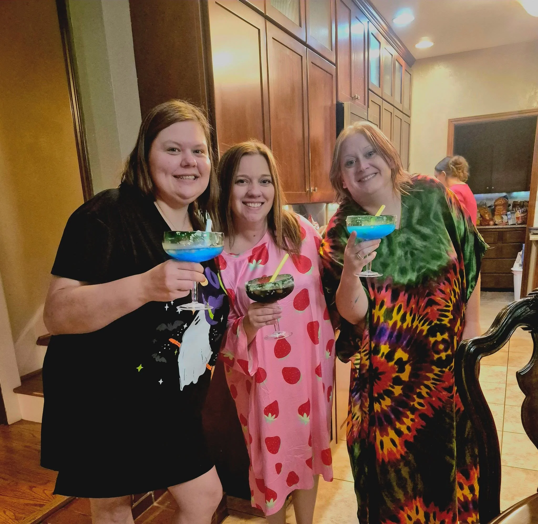 Group of friends enjoying colorful cocktails at a lively bar