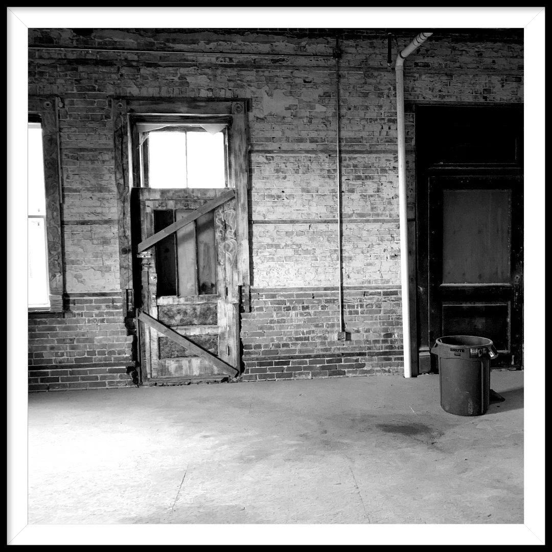Abandoned industrial space with rustic doors and exposed brick walls