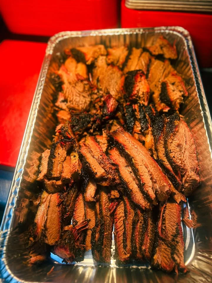 Sliced Texas-style smoked brisket in a serving tray