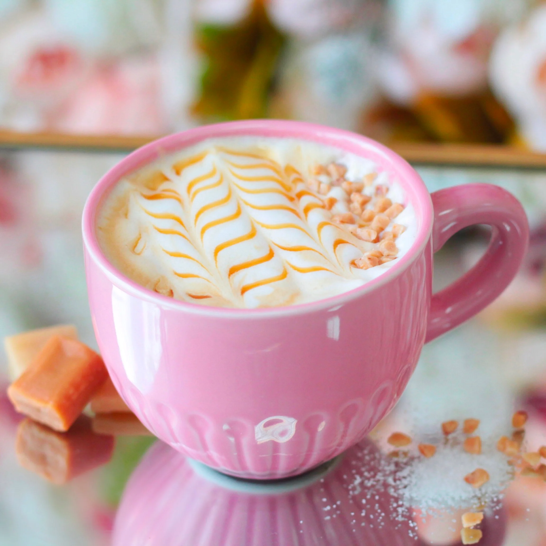 Delicious caramel latte art in a pink cup