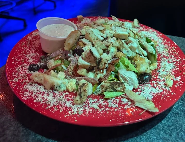 Grilled chicken Caesar salad with creamy dressing