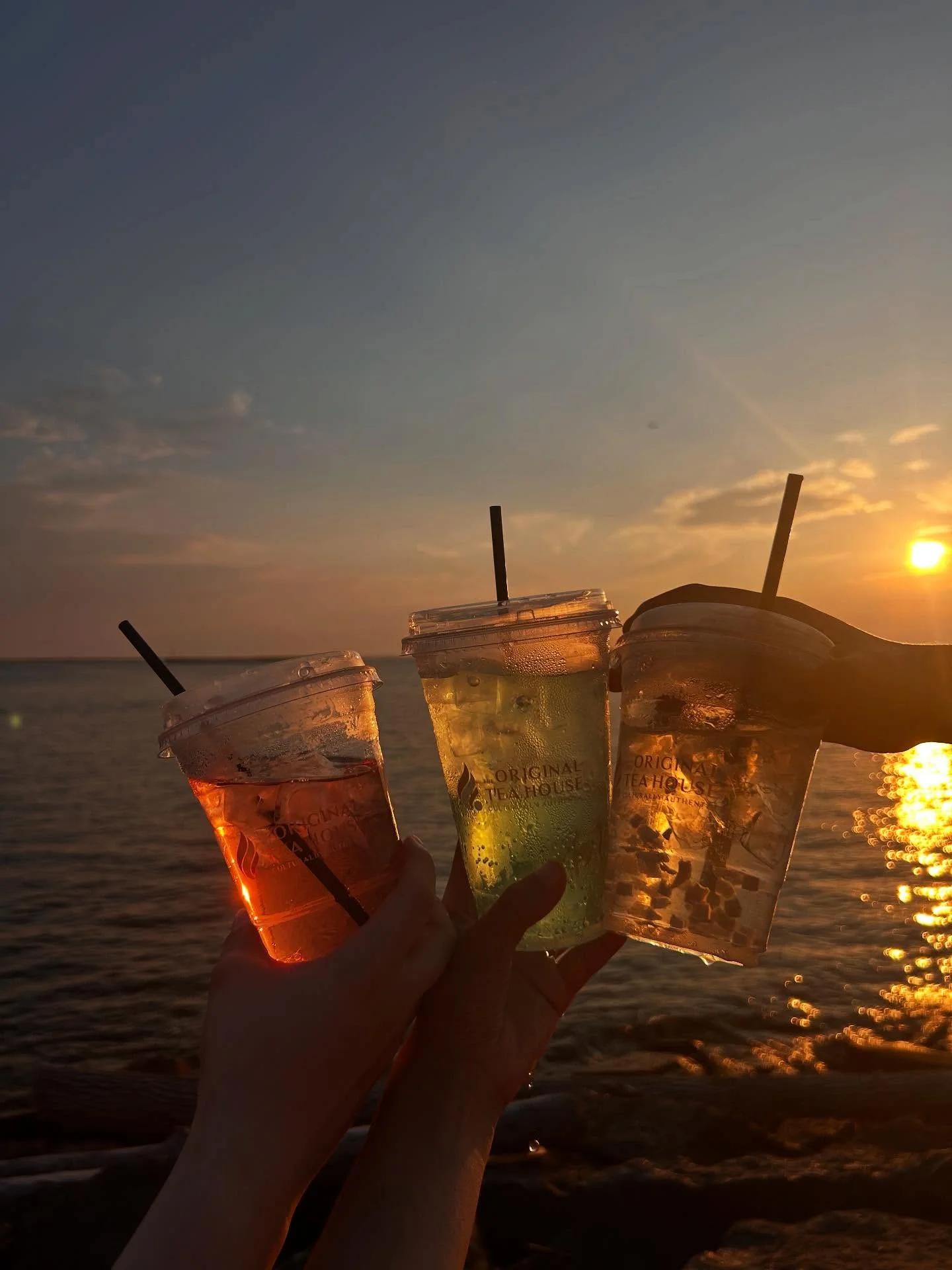 Colorful drinks at sunset by the water