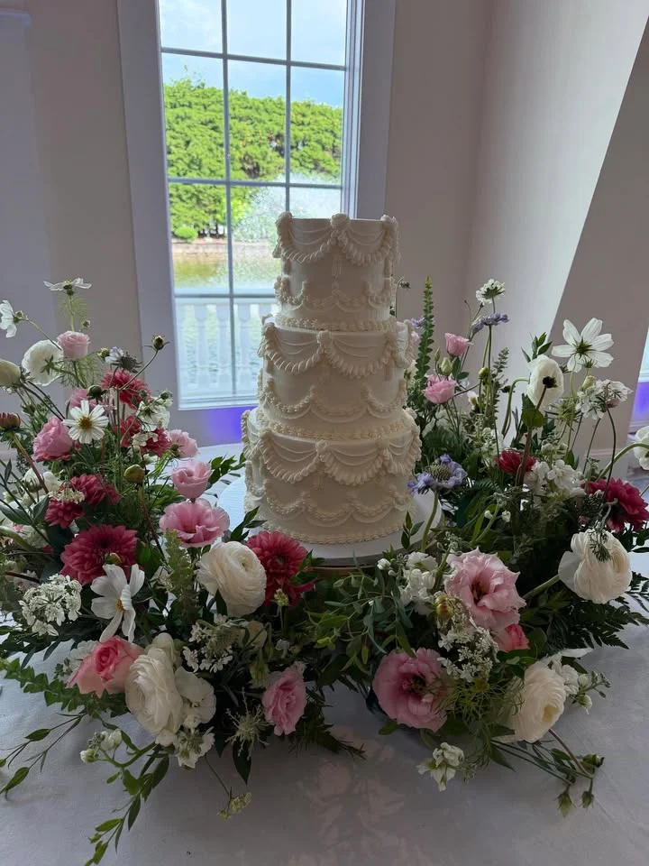Elegant wedding cake adorned with fresh flowers