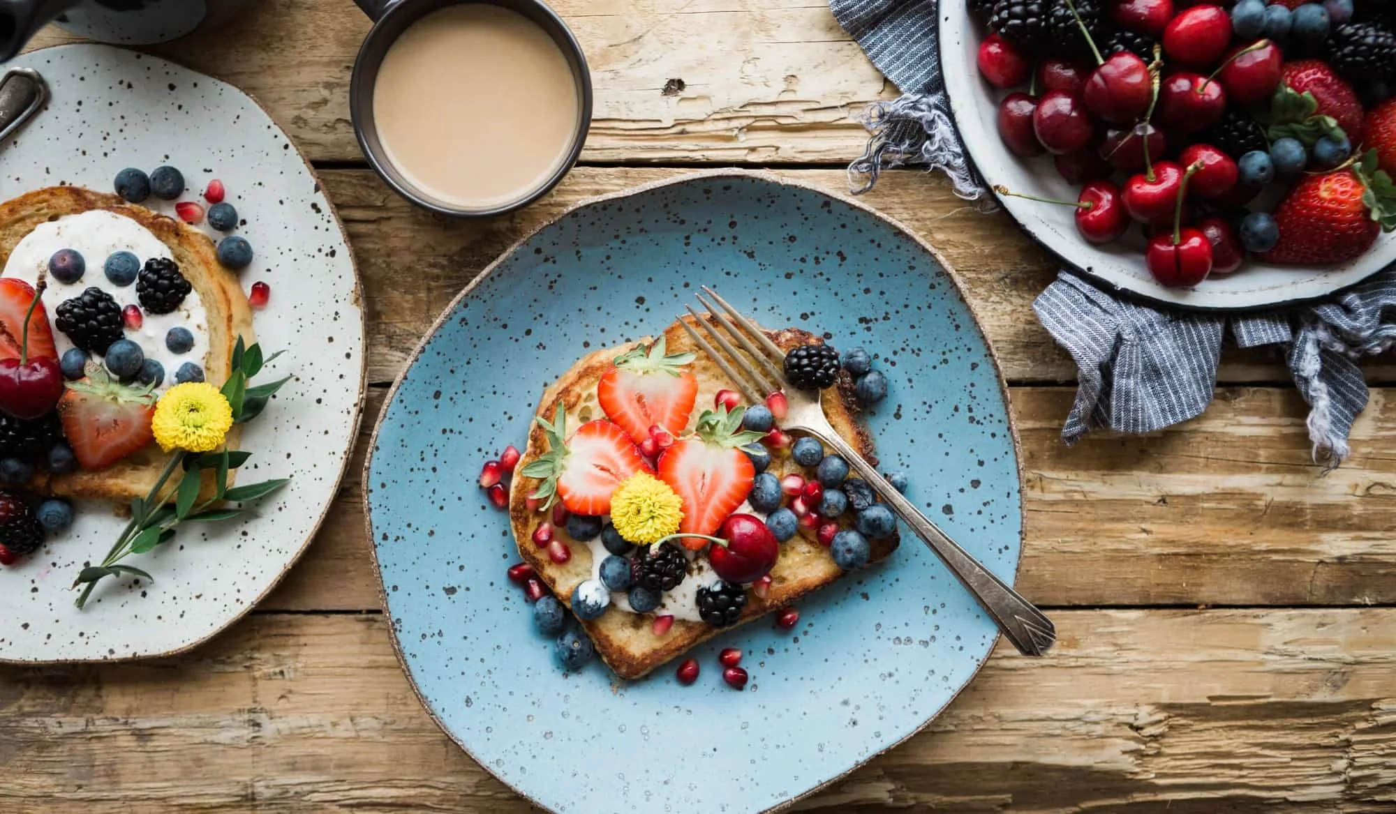 French toast topped with fresh berries and flowers