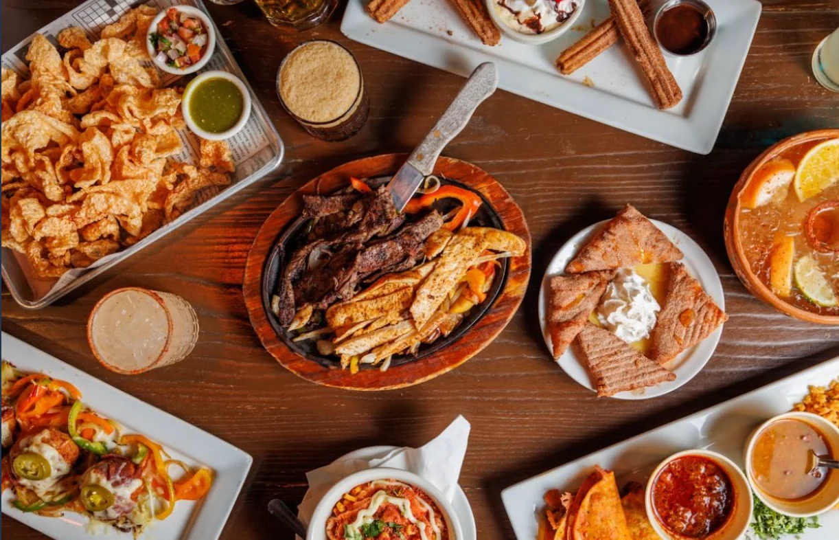 Sizzling fajitas platter with grilled meats and colorful peppers