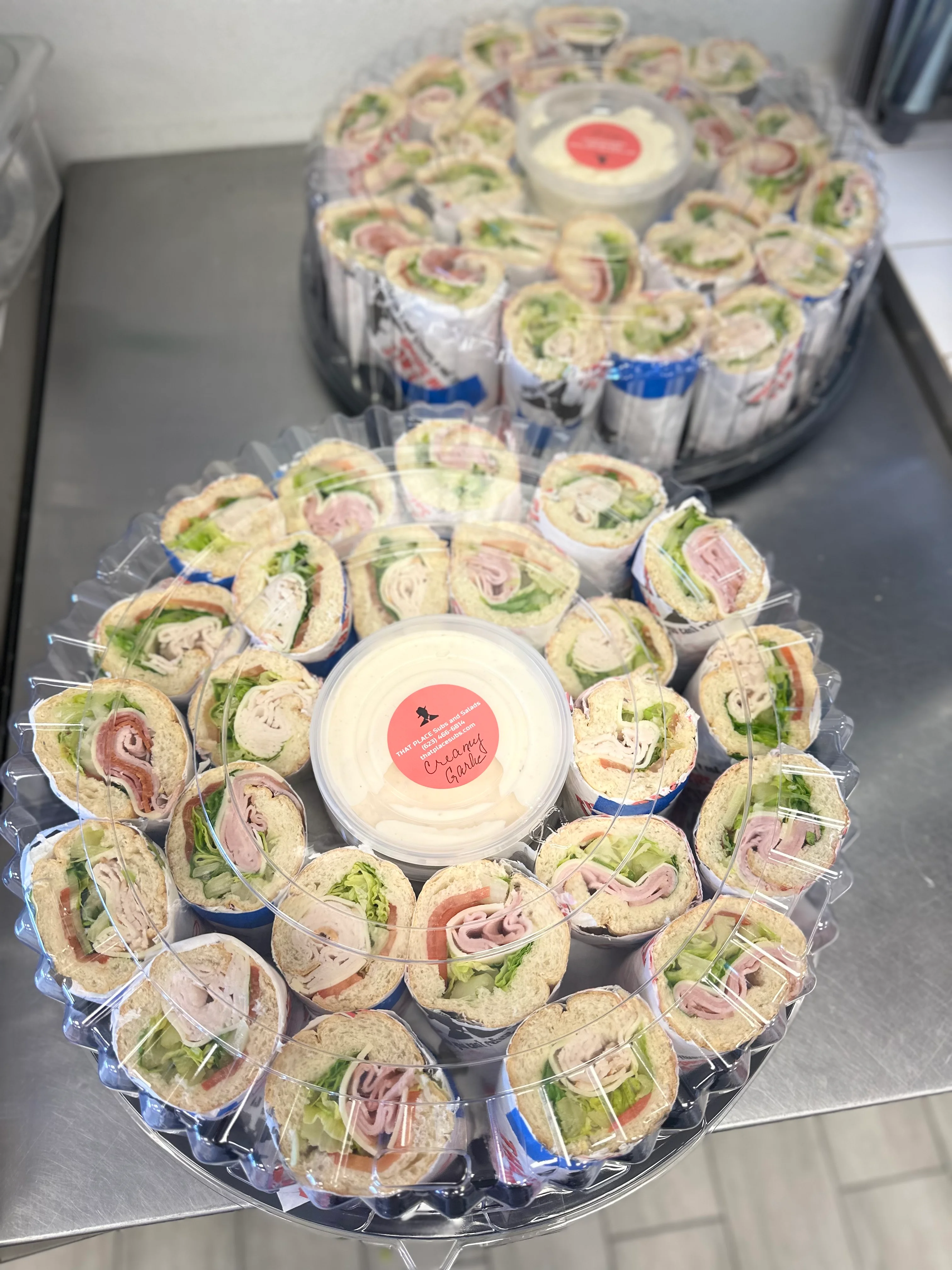 Platter of assorted deli wraps with creamy garlic dip