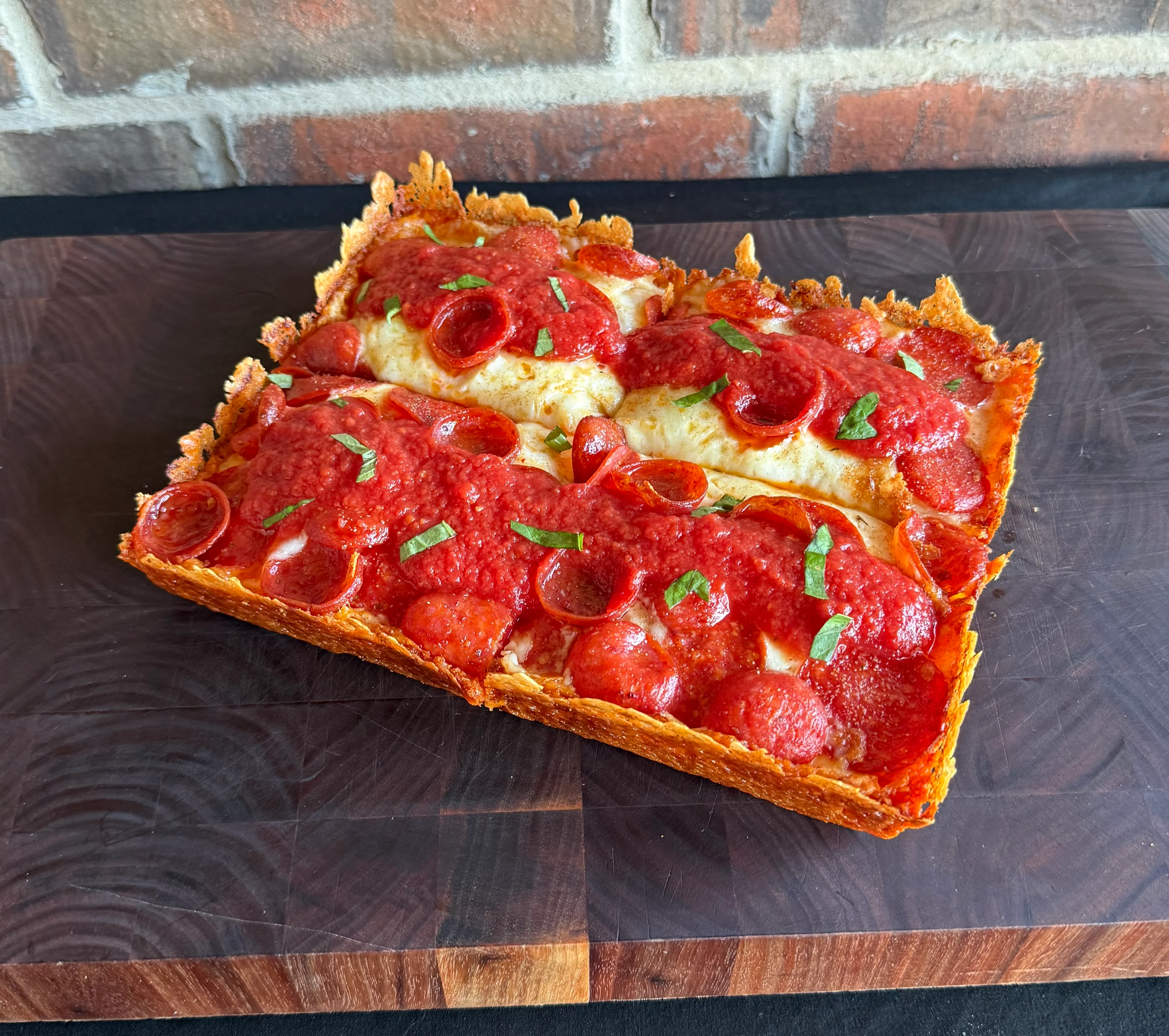 Chicago-style deep dish pizza with pepperoni and marinara sauce