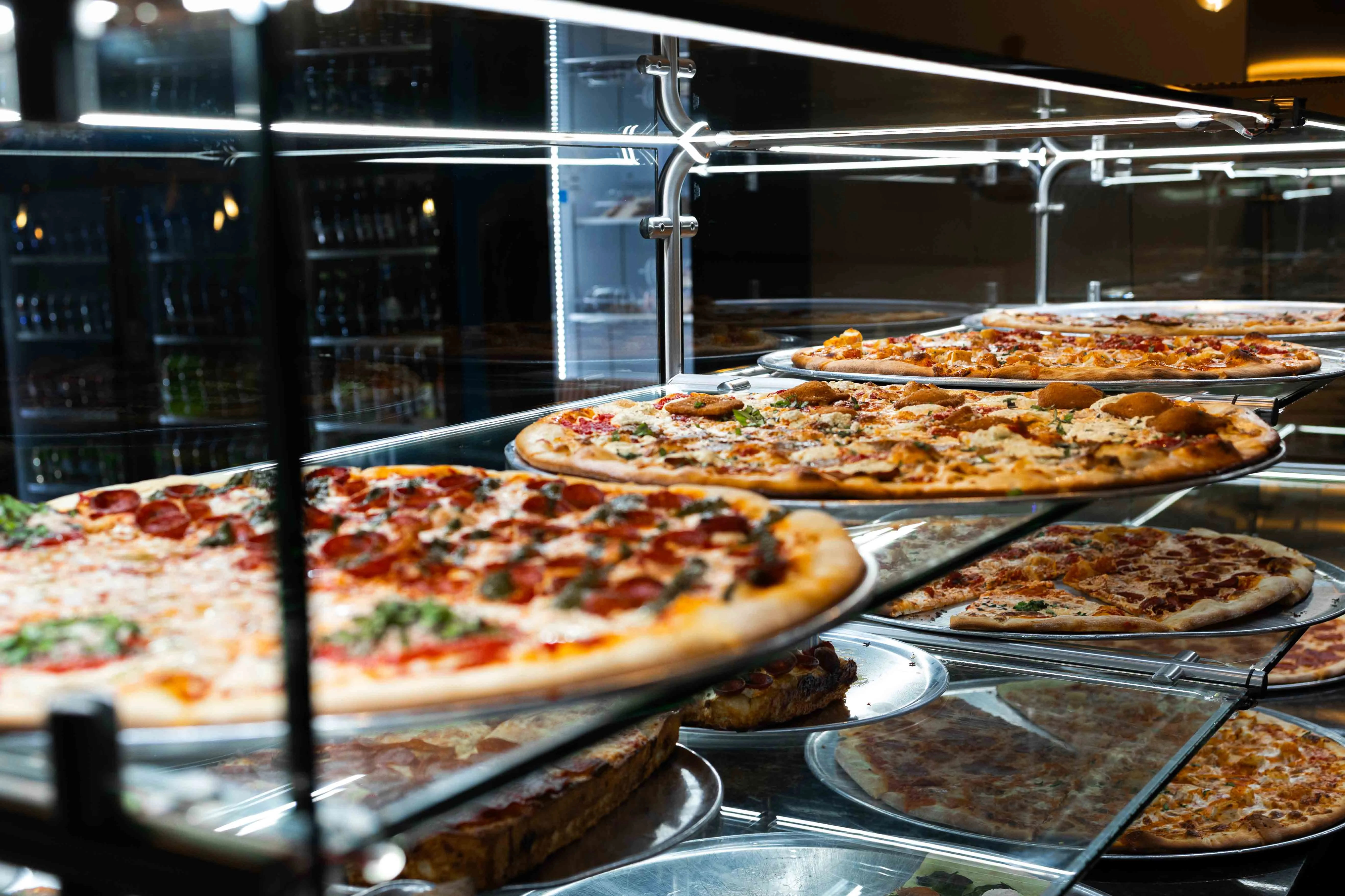 Variety of pizzas displayed in a restaurant