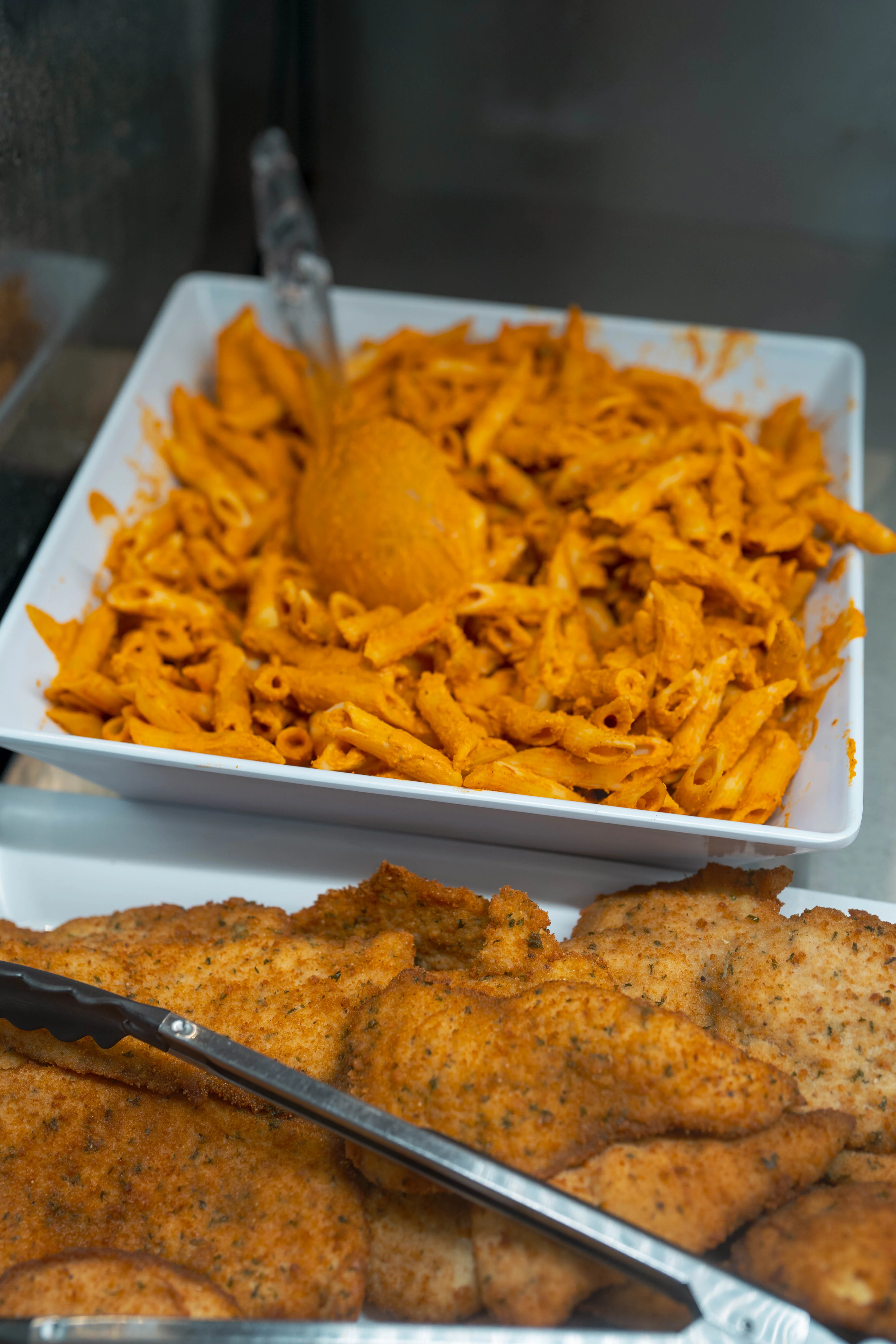 Creamy penne pasta with marinara sauce and crispy fried fish