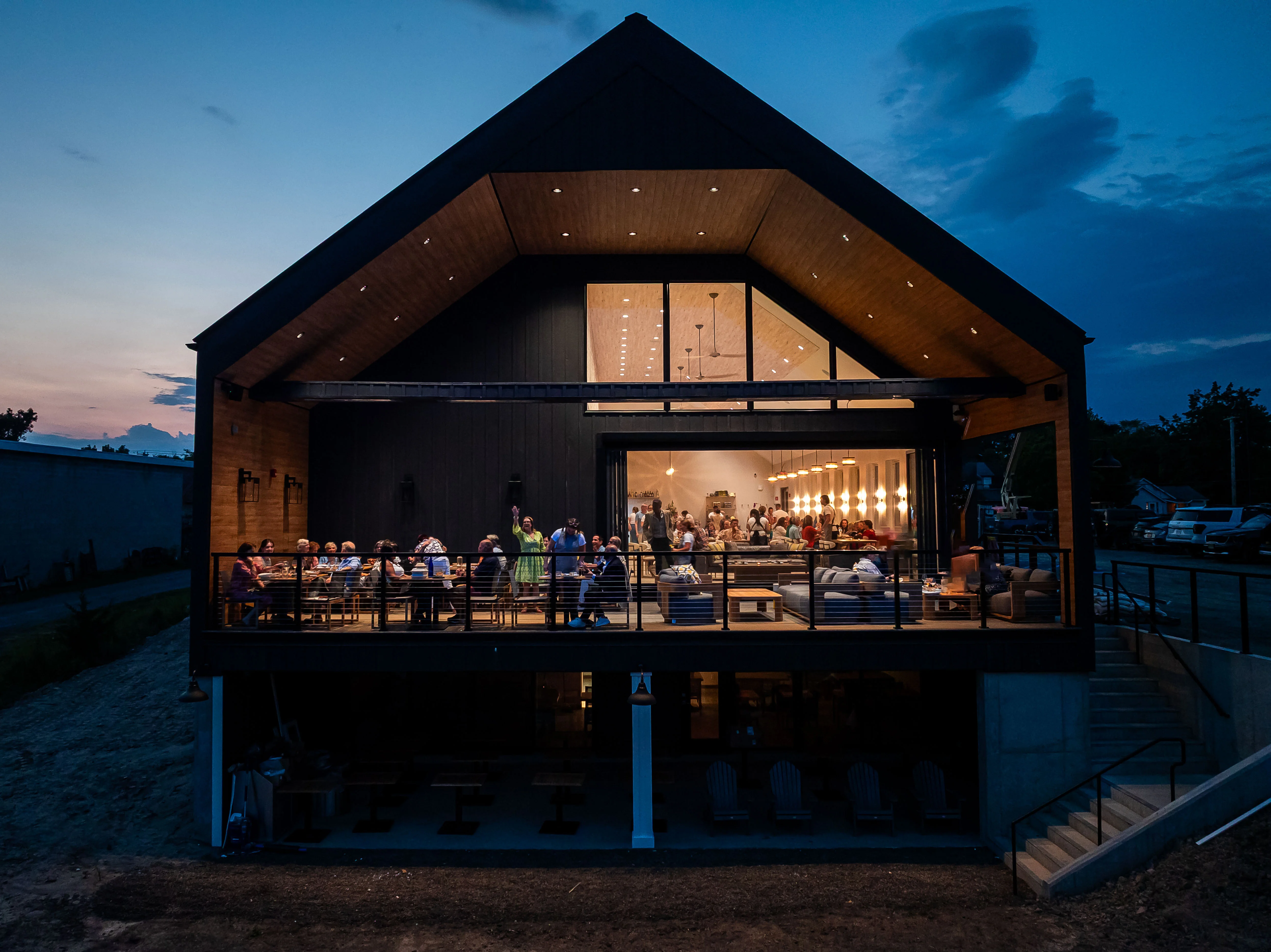 Modern restaurant exterior at dusk with outdoor seating