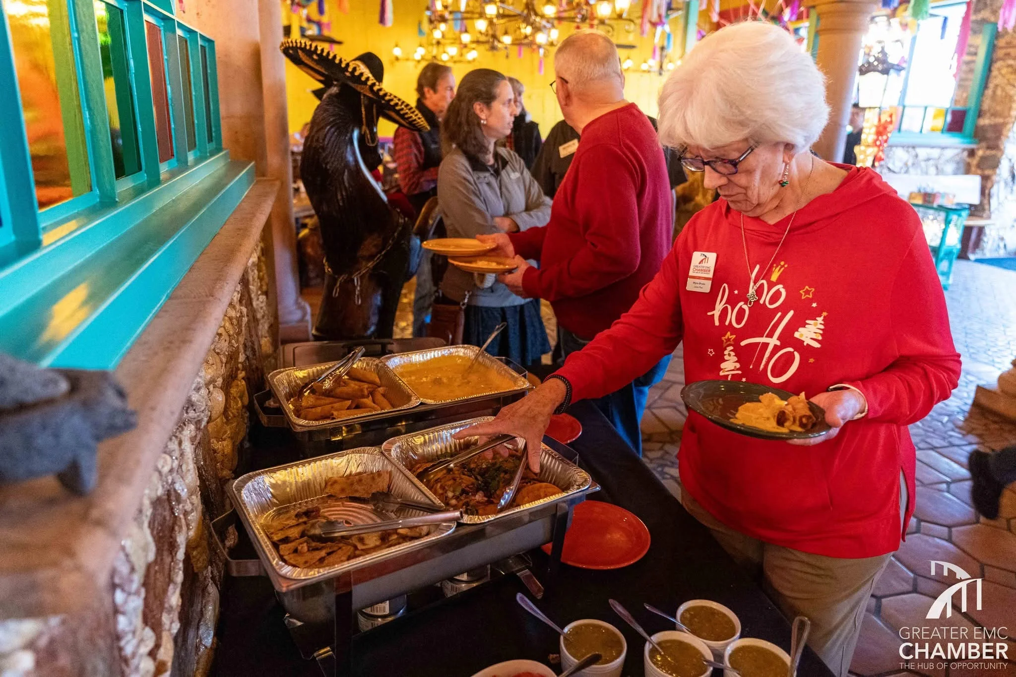 Guests enjoying a festive buffet with traditional Mexican dishes