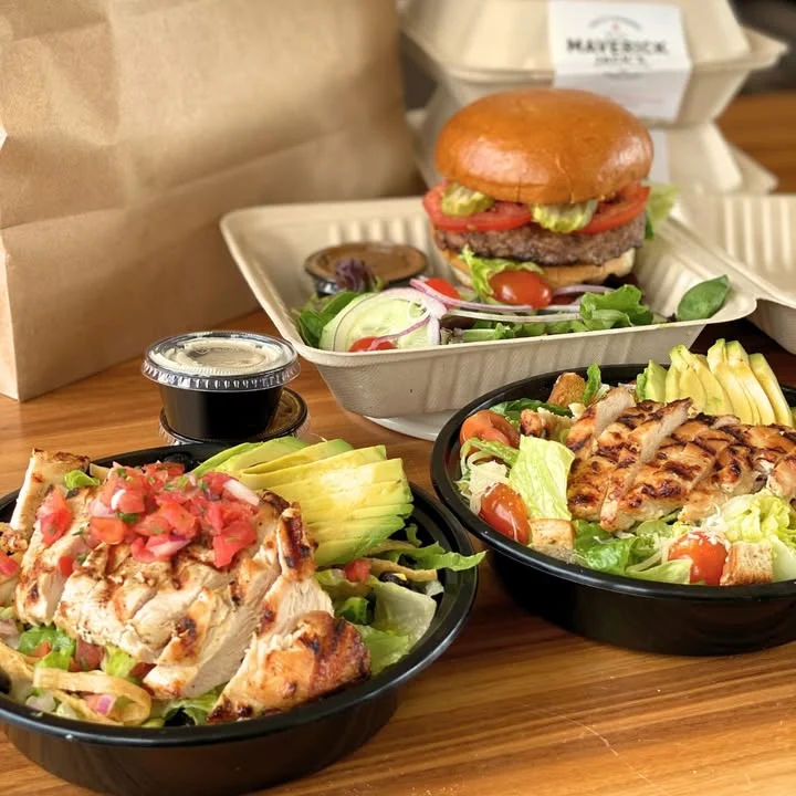 Grilled chicken salad and burger in eco-friendly packaging