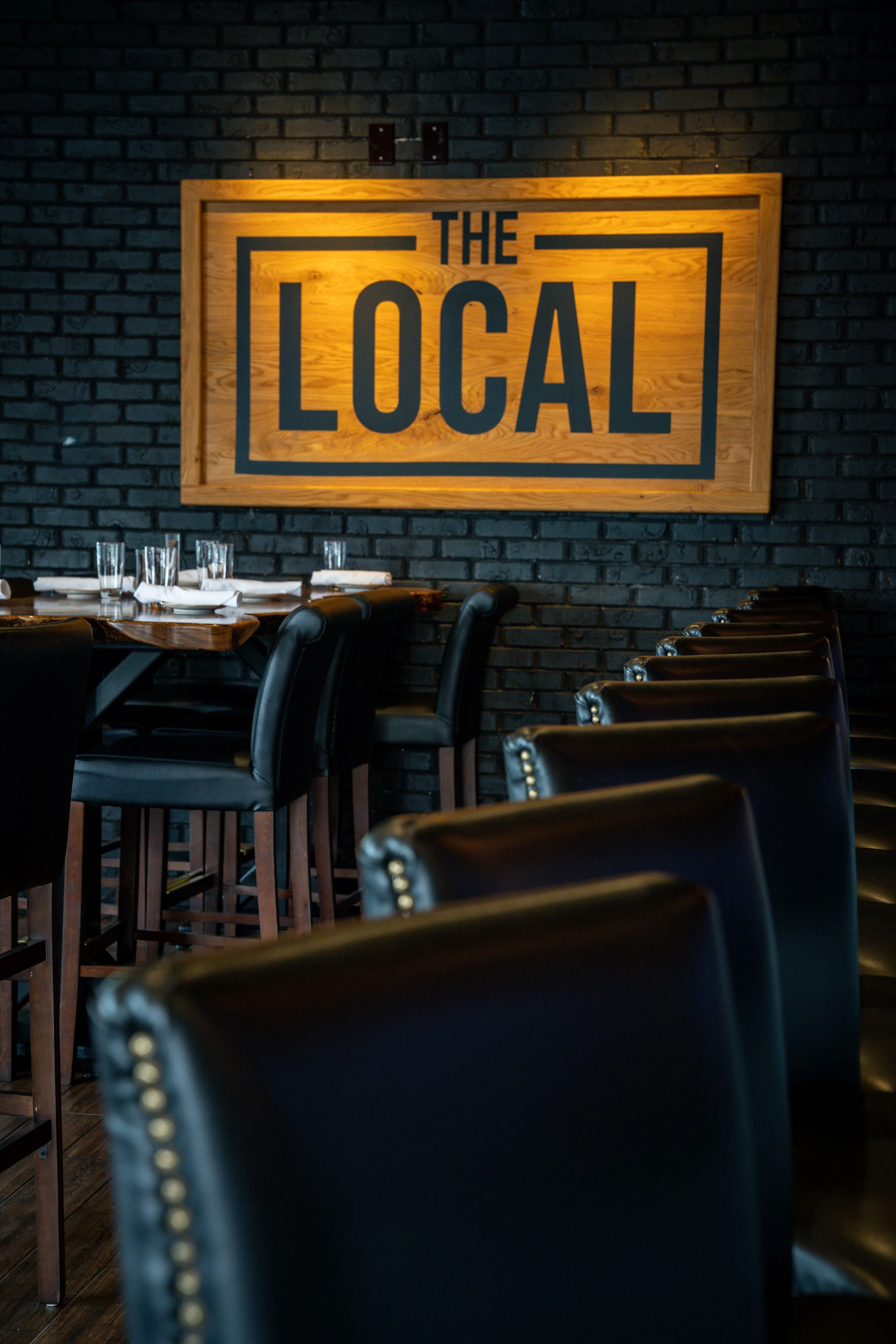 Cozy restaurant interior with wooden accents and black brick wall