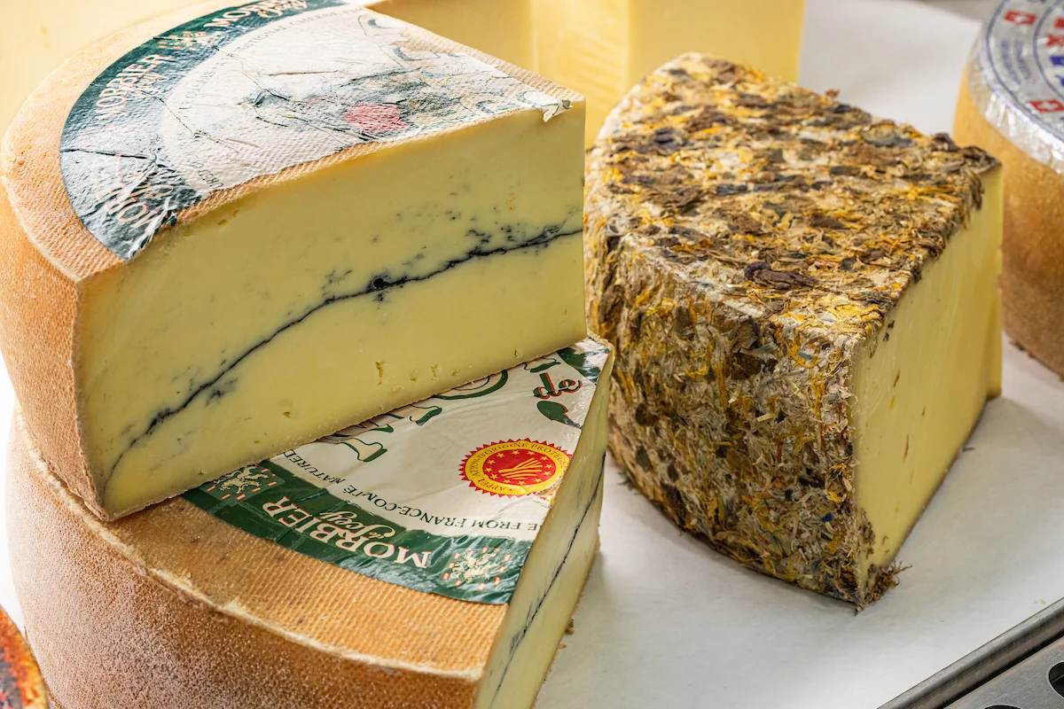 Artisan cheese selection featuring Morbier and other gourmet varieties