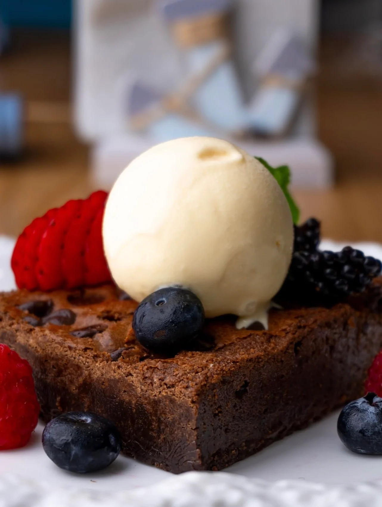 Decadent chocolate brownie with vanilla ice cream and fresh berries