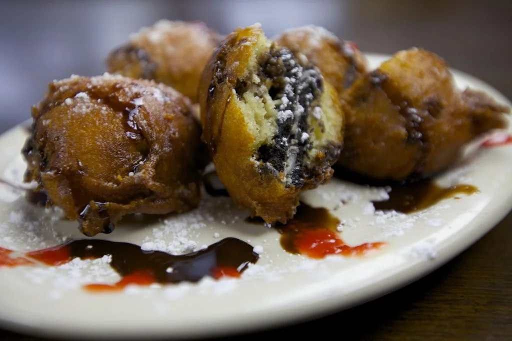 Deep-fried Oreos drizzled with chocolate sauce