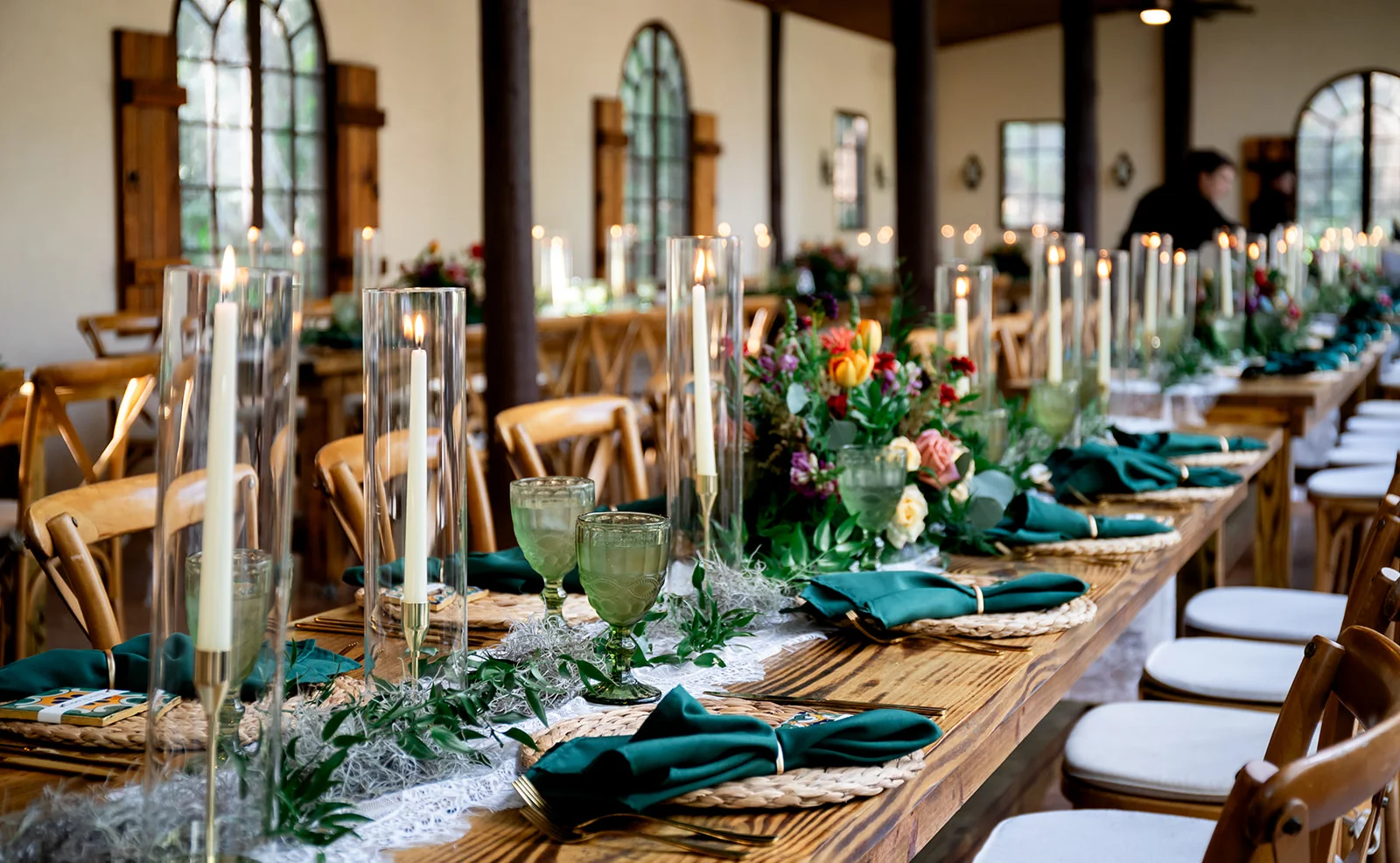 Elegant dining setup with candles and floral arrangements