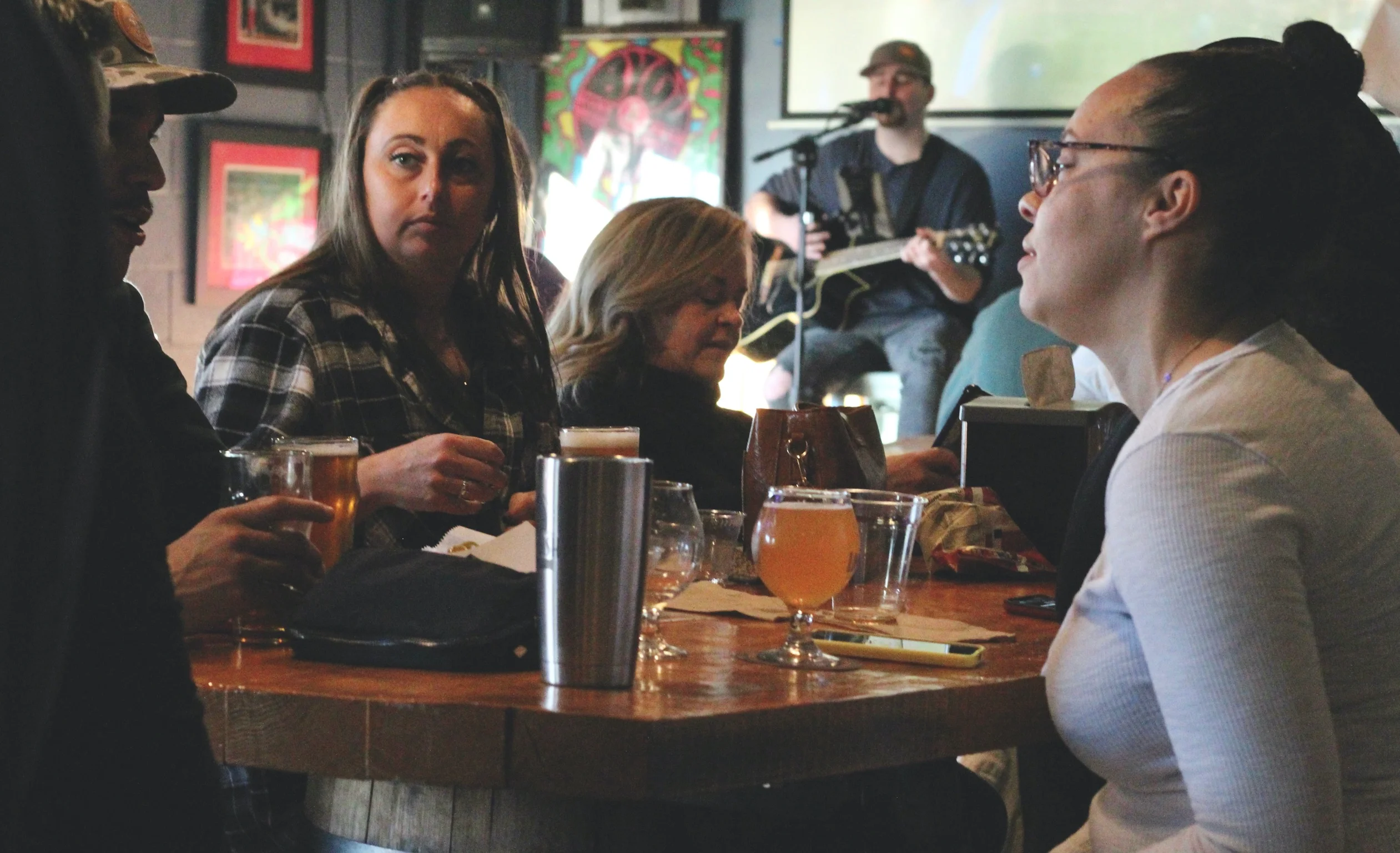 People gathered around a table at Lost Rhino Brewing Company