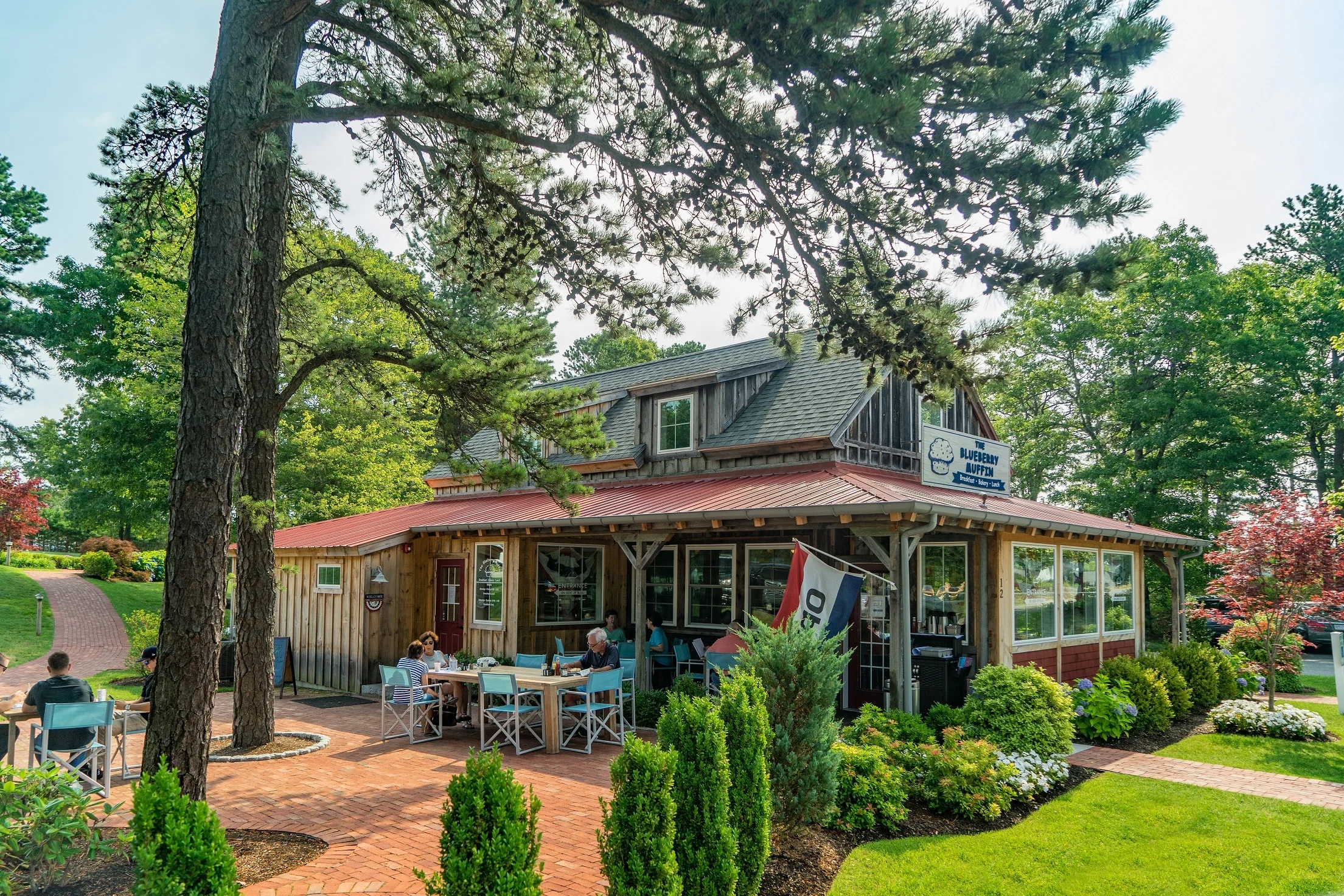 Charming restaurant exterior with outdoor seating and greenery