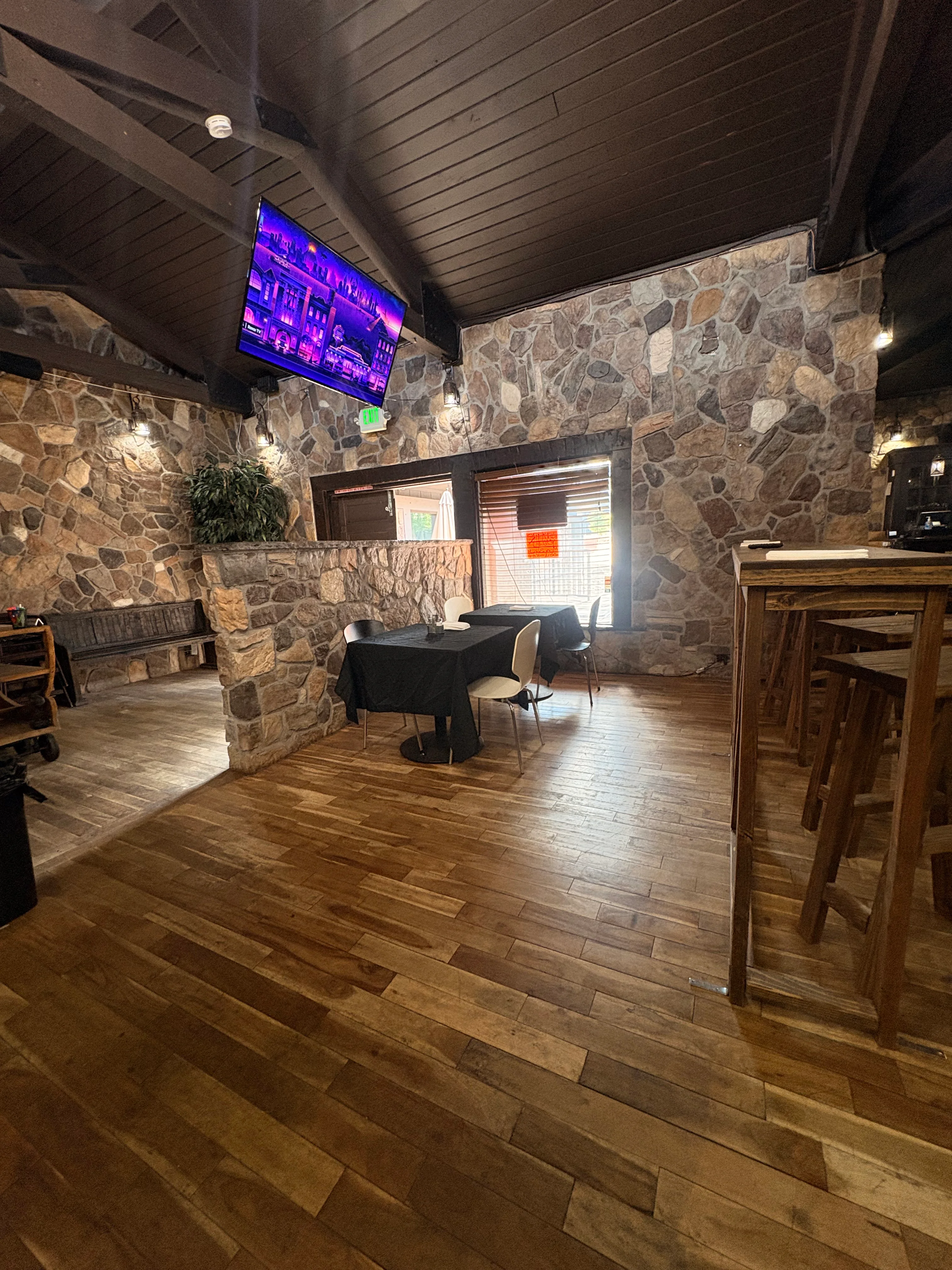 Cozy restaurant interior with stone walls and wooden flooring