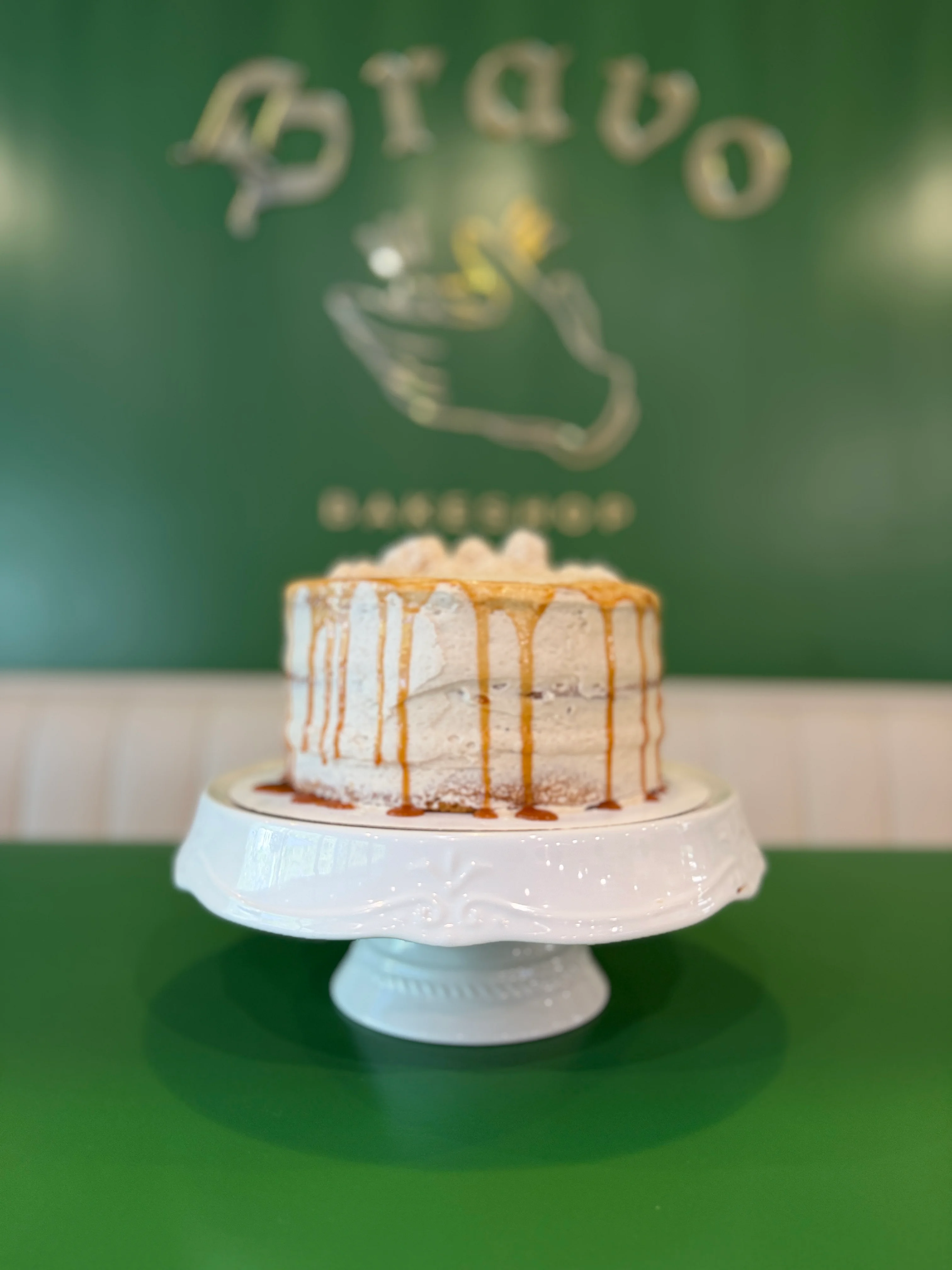 Decadent caramel cake on a white pedestal